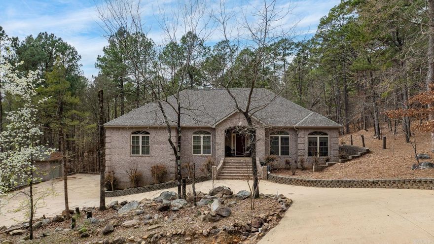 Exceptional custom-built brick home on 2 acres just steps from Pinnacle Mountain State Park! Fantastic floor plan with an open concept kitchen/dining/living combination. The great room is spacious with hardwood floors, tray ceilings, crown molding, and lots of natural light.  Granite countertops in kitchen with tile backsplash and maple cabinets with a breakfast bar and breakfast nook! This lives like a one level home with 3 bedrooms on the main level.  Handsome primary en-suite with lots of space.  Jacuzzi tub and walk in shower! Carpeted walk-in closet with a built-in dresser. Two bedrooms apart share a hall bath.  Bonus downstairs living with 2 bedrooms and another full bath. 3-car oversize garage with a workshop and shed. Double-paned windows throughout. French drain system. Woodburning fireplace with ceramic tile, raised hearth and blowers for living room and primary bedroom. New roof 2026! Great opportunity to own acreage near Pinnacle & Rattlesnake Ridge! See agent remarks!