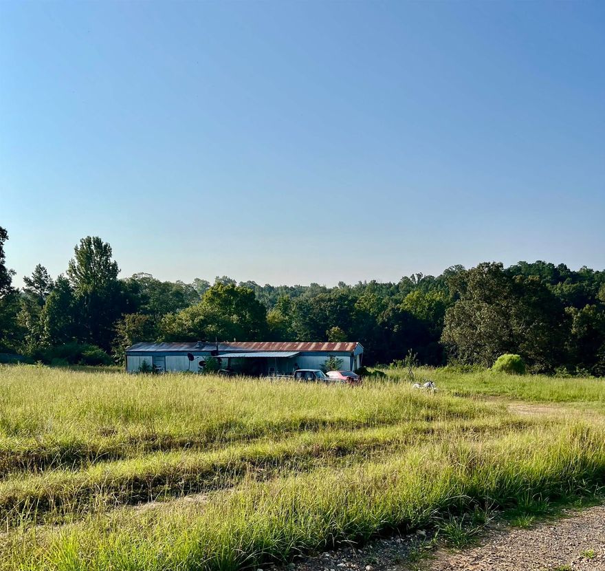 Ready to start a wonderful project!! 8.20 acres+/- With well, 2 septics, 3 mobile home cook-ups. (1) 924 sq. ft mobile home. Selling AS IS AGENT REMARKS