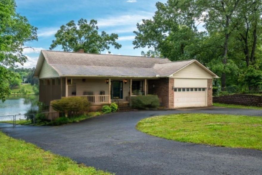 LAKEFRONT & BREATHTAKING SUNSETS! This 7 bedroom & 3 bathroom home has it all! On the main level is the large primary en-suite with double sinks, separate tub, and walk in shower + 2 bedrooms & 1 bath, a large kitchen, separate dining & eatin kitchen area overlooking the lake. The great room is open & invitng with a wood burning fireplace. Glass sunroom gives panoramic views of the lake that you will never want to leave. Downstairs can be locked off & rented separately: it is a perfect walk-out downstairs with kitchen, living, fireplace, and 3 bedrooms & 1 bathroom. Downstairs also has a heated and cooled multi-purpose room with garage door that could be used as a workshop or additional storage. There is a floating boat dock with 2 covered slips, lift, large patio seating, and a nearby storage shed for additional storage for all the extras & water toys. Bubba Brews is a 2 minute boat ride & Wal-Mart neighborhood market is 4 minute car ride! This home has everything: Views, Great Location and is treasure - very well maintained!