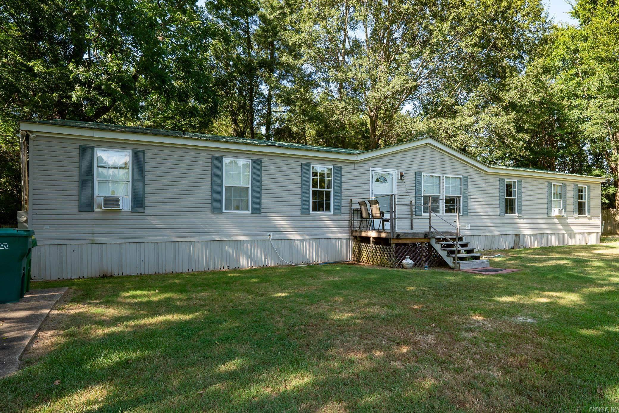 Welcome to peaceful country living just outside the city limits! Situated on a gorgeous, tree-shaded .78-acre lot, this well-maintained 4-bedroom double wide home offers the space and comfort your family has been looking for. Fully fenced and gated for privacy, this property is ideal for those who value both security and serenity. Enjoy the natural beauty of mature pecan and acorn trees, providing shade, character, and seasonal charm. Step inside to find two spacious living areas, perfect for relaxing or hosting guests. The open kitchen features ample cabinet space and a generous dining area, ideal for family meals and entertaining. The great room boasts a cozy fireplace, creating a warm and inviting atmosphere. Each bedroom offers plenty of space and storage, and the primary suite includes a bonus sitting area and a large en-suite bath. Outdoors, youāll appreciate the peaceful setting, mature landscaping, and a dedicated RV pad with electrical, water, and plumbing hookupsāa rare find. The home also features an FHA-approved foundation. Sellers request a 1 week delayed occupancy after closing. Donāt miss this one! Call today to schedule your private showing! Agents see remarks.