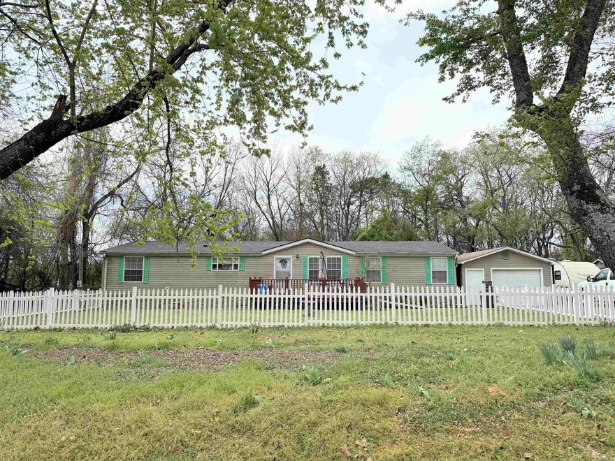 Welcome home to this beautiful and spacious 3-bedroom, 2-bath manufactured home featuring a desirable split floor plan. Inside, you’ll find cozy living spaces with a wood-burning fireplace, walk-in closets, and plenty of room to spread out. Step outside to enjoy the large front deck or relax on the screened-in back porch, perfect for quiet mornings or evening gatherings. The property is shaded by mature trees and offers great outdoor features including a storm shelter, detached one-car garage, and a handy work shed. With a new roof installed in 2021, this one checks all the boxes!