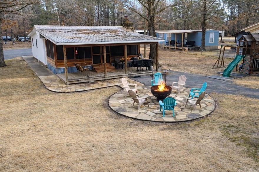 CUTE house on 2 lots only 5 minutes / 2.3 miles to Sugarloaf Marina on Beautiful Greers Ferry Lake.  House comes completely furnished with everything you need to live full time or be a weekender. House was built in 1970, redone in 1995 and the sellers did another update in 2024 with new: windows, doors, paint, flooring and appliances. Also comes with a stackable washer & dryer. 2 full bedrooms and 2 full bathrooms. Enjoy all day comfort on the screened in porch or the covered deck, a fabulous fire pit, lots of room for outdoor entertaining on 2 fenced lots, comes with an RV that has its own cover,  2 out buildings to park a boat or store your lake toys. It's lake season, give me a call and come check it out.  Please see agent remarks.