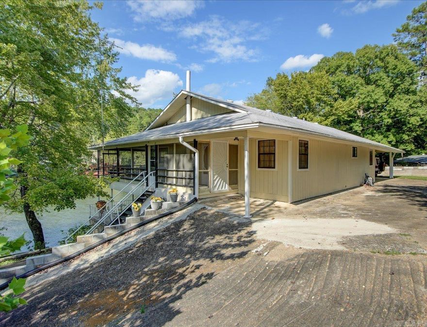 AMAZING LOCATION! A waterfront Retreat on Lake Catherine! This home was built by a craftsman and used for many years as a family lake house cabin. A solid slab supports the 2 stories and basement. The wood interior creates a warm, fun atmosphere where everyone knows they can relax and enjoy lake living. The main floor enjoys an open floor plan with living, dining, and kitchen, as well as 2 large bedrooms, baths, and a laundry room.  The basement area is an open floor plan with a game/family room, bedroom, kitchen, and bath. Both levels enjoy a wide deck running the length of the home with amazing views of Lake Catherine. The main level deck is screened for year-round enjoyment.  Lakeside, there are concrete, covered boat stalls for multiple boats and a concrete bulkhead to protect the shoreline. Only 6 minutes to Remmel Dam and right across the Ouachita River there are many trails at Lake Catherine State Park.  Live full time by the lake or make it your own lake family retreat for endless vacations. This is the perfect location for you.   Agents - Call Showing service to schedule all showings.
