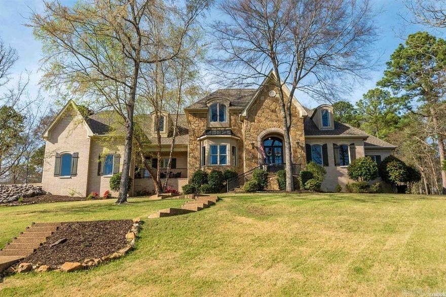 Nestled in a natural oasis surrounded by trees, this beautifully custom-built, updated home features a front balcony perfectly positioned for stunning Red Oak Lake views. The freshly painted, versatile floor plan offers 4 bedrooms, 3.5 baths, and an office used as a 5th bedroom. A mudroom with removable cubbies provides a perfect drop zone. The extra-large, fully remodeled chef’s kitchen boasts endless storage, a walk-in pantry, gorgeous new countertops, instant hot water, and premium appliances, including a WiFi Café double oven and 6-burner gas cooktop. Entertain in spacious living areas with updated lighting and two fireplaces featuring sleek new tile. The primary suite is a private retreat with new hardwood floors and spacious his-and-hers closets with added upper storage. Upstairs features 3 bedrooms with walk-in closets, 2 full baths (one with new tile), a new linen closet, upgraded insulation, and brand-new carpet. Complete with a freshly painted front door and shutters, a garden bed, and a garage with extensive built-in shelving, this pristine property is a must-see. Agent Owned.