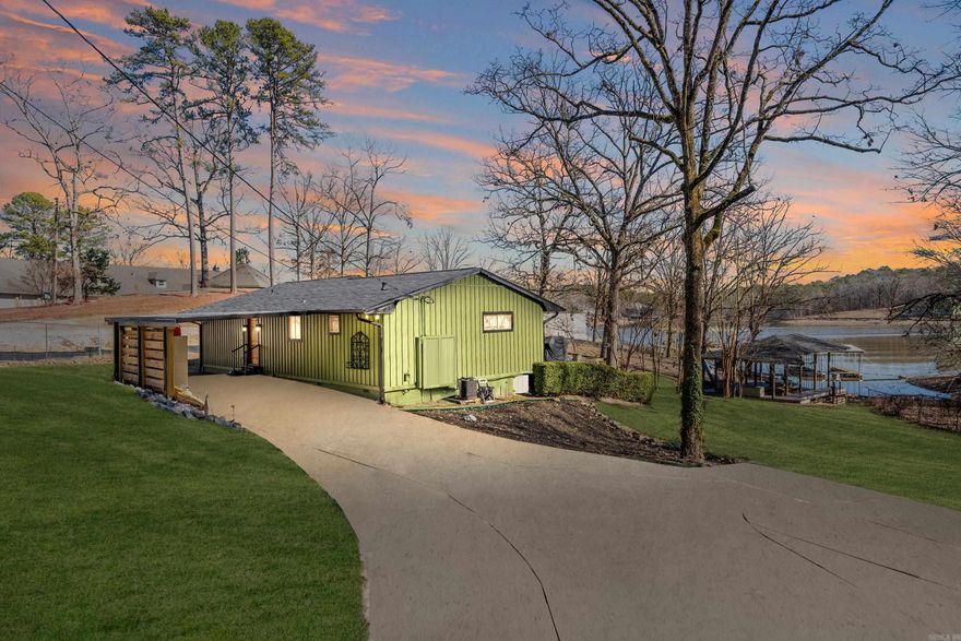 This charming home offers a peaceful retreat in a serene setting. Situated on a large lot with a gated entry, ample parking and located on a dead-end road. As you step inside, you'll be greeted by an open kitchen/living room area that showcases stunning views of Lake Hamilton from nearly every room. The split bedroom layout ensures privacy, with each bedroom boasting its own full bathroom and walk-in closet. The primary bedroom is generously sized and could easily be divided into 2 separate bedrooms if desired. Take the party outside where you'll enjoy relaxing in your hot tub under the stars or on the 2 decks overlooking 112’ of lake frontage with an easy walk down to your covered boat dock with a sling lift, 2 PWC parking areas, and a PWC lift. For added convenience, the refrigerator, washer & dryer, and hot tub are included in the sale. Recent updates include a new roof on both the house and boat dock in 2023. Additionally, the exterior board and batten have been repaired or replaced, and the entire house has been freshly painted. A new carport and gutters were installed in 2023 and 2024, while the deck was expanded in 2022 and 2023. A new water heater was also added in 2024.