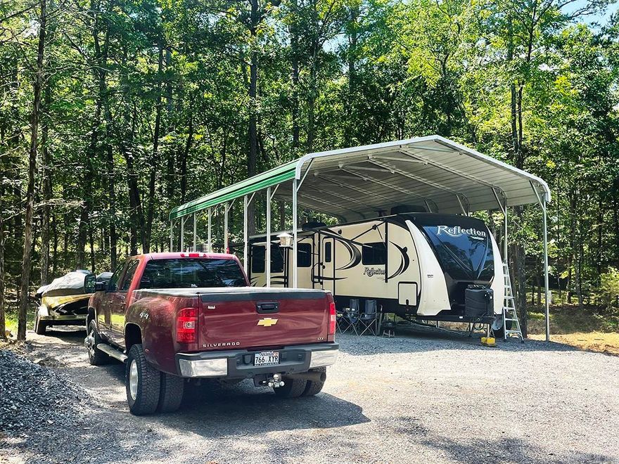 This is Rare-Private RV lot that is unrestricted. Just 5 minutes to Choctaw Marina and boat launch. Which is setting on Beautiful Greers ferry Lake (40,000 Acres). Hospital and Clinton are close bye. Conway on I-40 is less than one hour away. The builder brought in over 55 loads of SB2 gravel for the circular driveway. Built big enough to bring just about anything in. This is also a good lot for a house or a mobile home. Petit Jean provides the electric (50.30 amp/120) and fiber optics. New 1000-gallon septic tank. Metal Building is 38' x 24' x 15'. Plenty of room for all your Lake toys and parking.