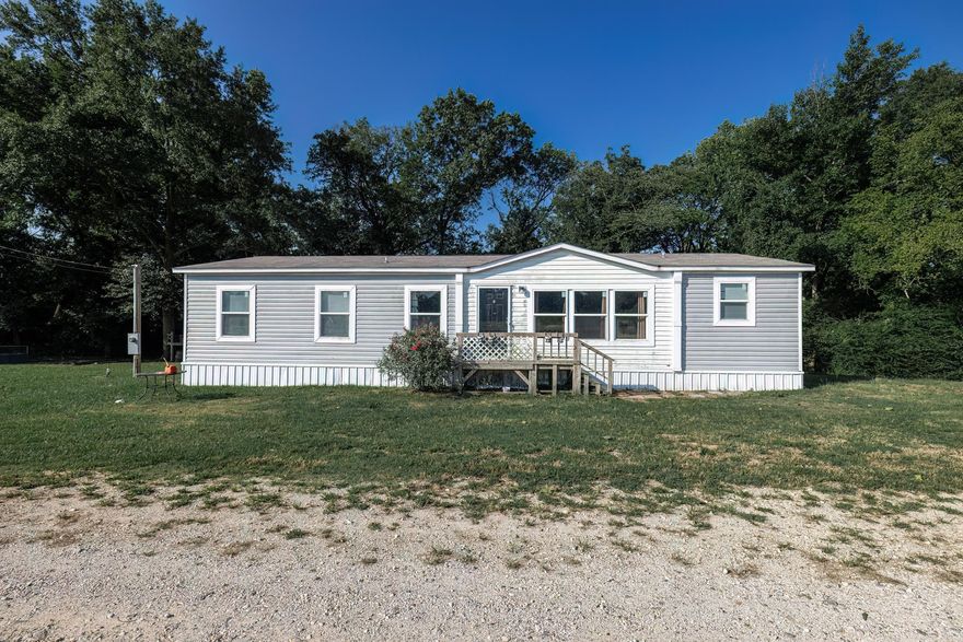 Nestled on 3 picturesque acres in Okolona, this charming 3 bedroom, 2 bath double wide offers a perfect blend of modern amenities and rustic charm. Built in 2018, the home boasts an extensive septic system and features an open living room and kitchen area with delightful farmhouse accents. The spacious kitchen includes a large pantry, ideal for storage and organization. Each bedroom is generously sized, providing comfort and ample space. The property is bordered by a beautiful creek, adding to its serene and scenic appeal. Additional highlights include a fenced area for pets or livestock, a tire swing for endless outdoor fun, and much more. Conveniently located just a short drive from I-30, this home offers both tranquility and accessibility.