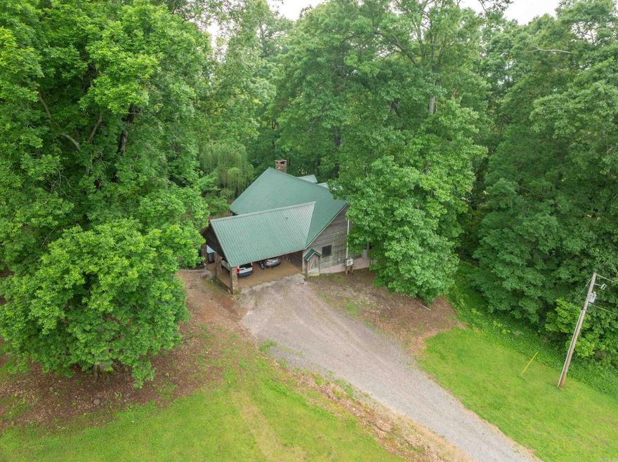 Welcome to your private countryside escape! Nestled on a picturesque parcel of land, this one-of-a-kind property features a beautifully maintained main country home and a charming retro cabin, all set against the serene backdrop of a meandering creek. The main residence offers a perfect blend of rustic charm and modern comfort, with spacious living areas, exposed wood beams, and large windows that invite in natural light and views of the surrounding landscape. Enjoy your mornings on the expansive porch with a cup of coffee and the peaceful sound of flowing water nearby.  Just a short stroll away, the vintage-inspired cabin is a nostalgic nod to simpler times—complete with wood paneling, a cozy wood-burning stove, and a welcoming front porch. Ideal for guests, a rental opportunity, or a creative retreat. Outside, mature trees provide shade and privacy, while the creek adds a touch of tranquility and natural beauty year-round. The converted barn serves as a bar with a pool table and more, so family or guests have the ability to enjoy evenings in a bar like setting.  Whether you’re relaxing by the water, gardening, or stargazing this property offers perfect country living.