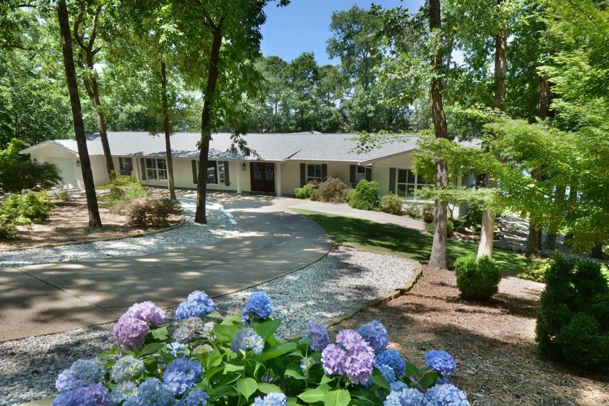 Nestled along the serene shores of Lake Hamilton, this exquisite 4 bedroom, 3-1/2 bath home epitomizes luxury living at its finest. Recently renovated with meticulous attention to detail and boasting high-end finishes throughout, this residence is a testament to modern elegance and comfort. Spanning across a generous 1.83 acre lot & 342 feet of lakefront, which is rarely available,  this expansive one level home offers ample space for both relaxation and entertainment close to all amenities of Hot Springs. With 4 bedrooms and 3-1/2 baths, including additional area for office or guest suite, there's plenty of room to accommodate family and guests comfortably. The heart of this home is its gourmet kitchen, equipped with top-of-the-line appliances, custom cabinetry, and expansive marble countertops. Prepare to be captivated by breathtaking vistas of Lake Hamilton from nearly every room in the house. Floor-to-ceiling windows invite natural light to flood the interiors, creating a seamless connection between indoor and outdoor living spaces. Step outside to discover your own private paradise, where lush landscaping and panoramic lake views set the stage for outdoor enjoyment.