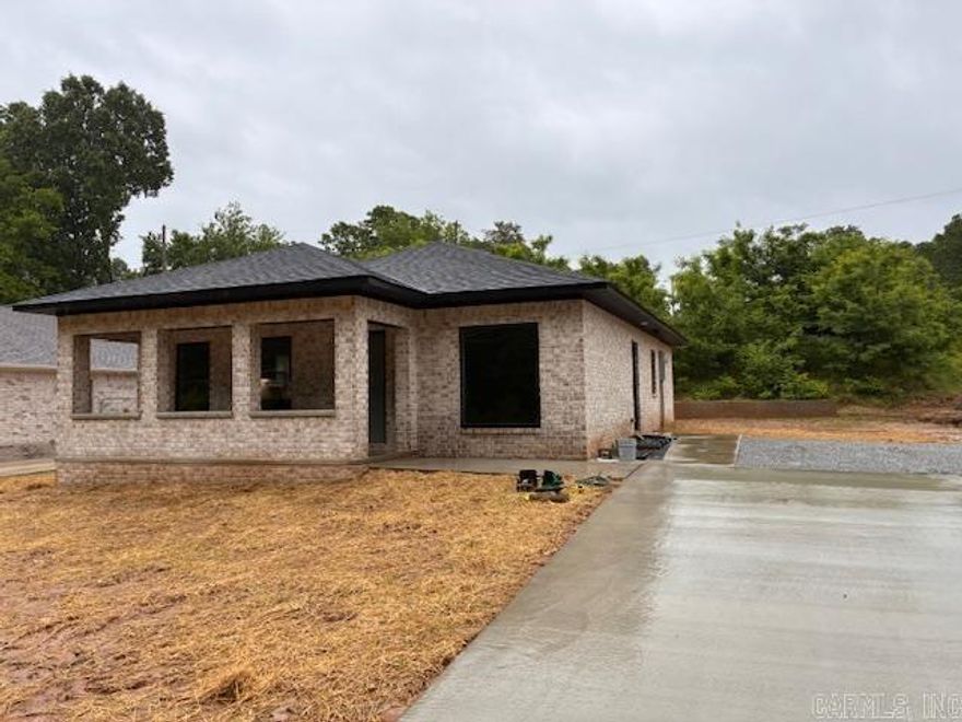 New construction. 9ft ceilings throughout. Custom cabinets in kitchen with concrete stained floors. Builder's one year warranty. additional lot adjacent to the West of the home.