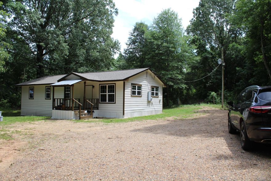 MOVE IN READY - FULLY UPDATED 3 bed, 2 full baths with approx. 1200 sq. ft. of living space situated on approx, 2.07 wooded acres in a rural setting.  Central AC & Heat (Only 1 year old).  Roof only 6 months old.  Range and refrigerator convey with sell of home.