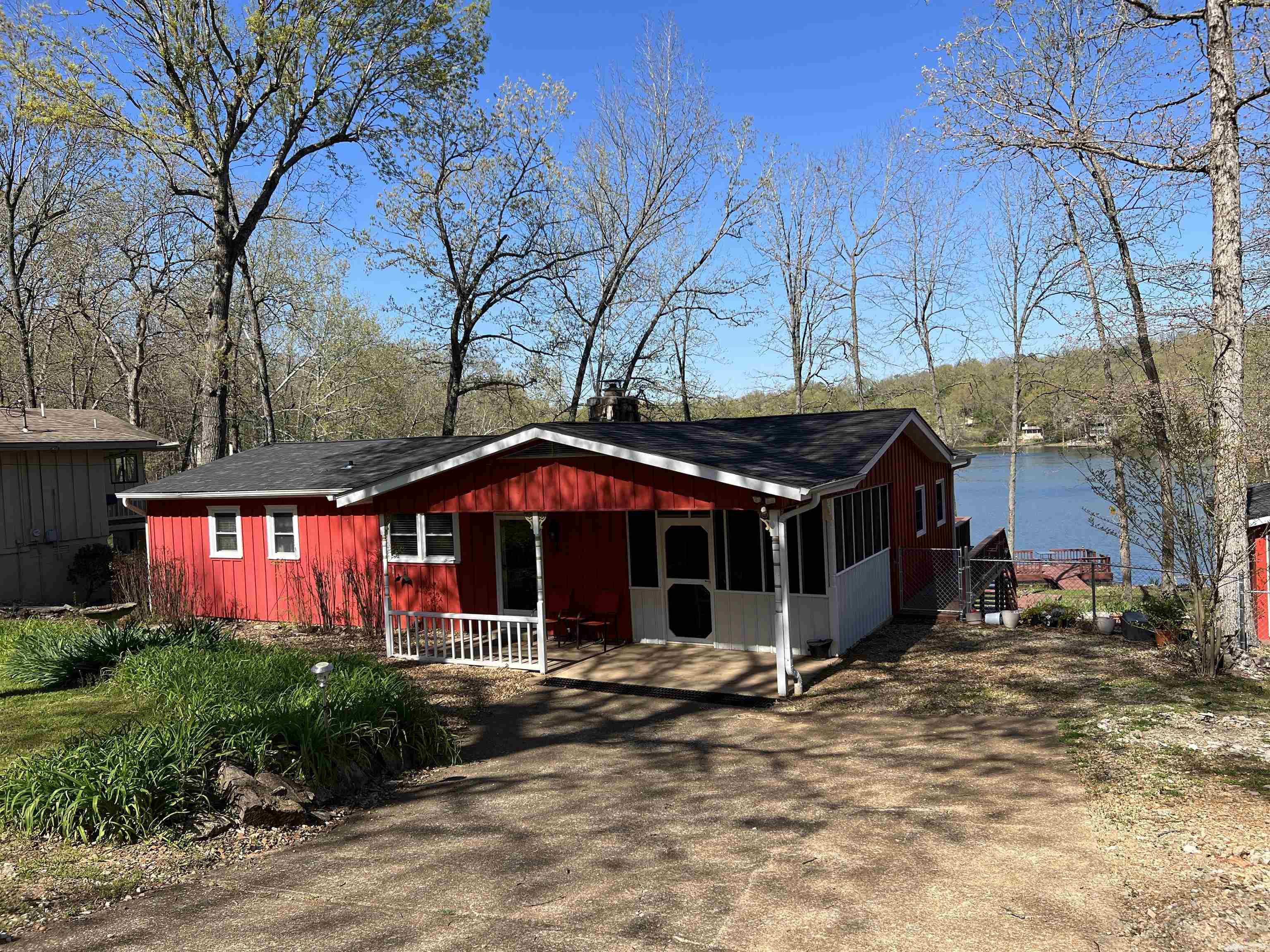 Stunning Lakefront Property! Prepare to be amazed by this beautiful lakefront residence in Cherokee Village! Upon entry, you'll be captivated by the stunning view of the lake before you. The house features a spacious layout with defined areas. Use the front room as a formal dining area or a cozy den. On the left, discover a well-appointed kitchen with ample counter space, perfect for entertaining on relaxing lake days. The living room seamlessly connects to the kitchen and showcases an impressive rock wood fireplace for warmth during winter. Both the kitchen and living room offer scenic lake views. Descend into the sunroom, where natural light fills the space through skylights, offering a 180-degree view of Lake Cherokee. Outside, enjoy your morning coffee on the deck or take a leisurely stroll down to the dock. Towards the front, a new insulated 27x27 shop awaits, elegantly finished inside. You can also relish the lake vistas from the shop, making it an excellent space for storing your lake equipment or accommodating extra guests with convenient 30 amp plugs. And there's more ā get in touch with us today for additional information!