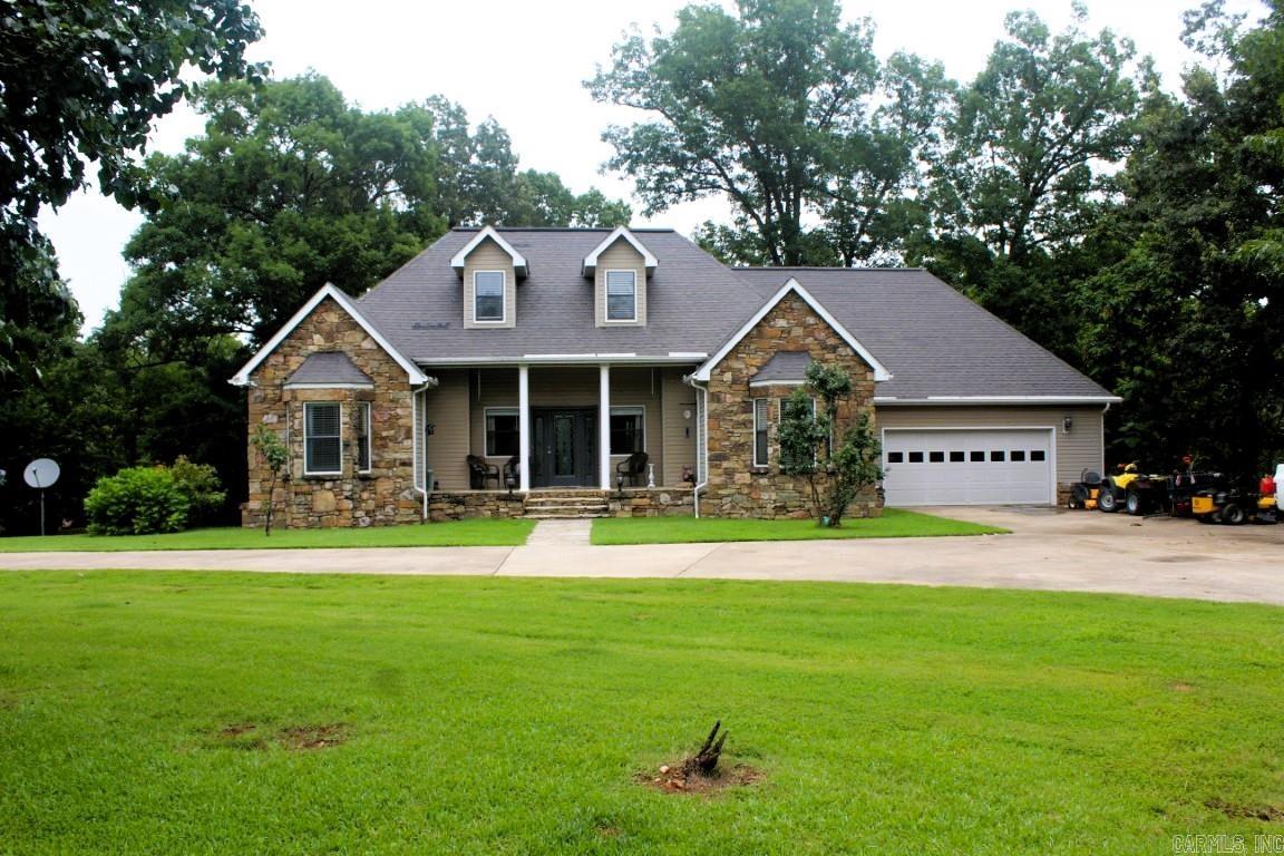 14020 East Highway 74, Marshall, AR – Spacious Home on 3.25 Acres in the Ozarks | $289,000 Listing No. 025042 Welcome to this charming 5-bedroom, 3-bath home nestled on 3.25 beautiful acres in scenic Searcy County. Located just off Highway 74, this 2,015 sq ft two-level home offers both space and comfort, along with a convenient location—just a short drive to Mountain View or Marshall. Step inside to a bright and open kitchen/dining combo, cozy living room with a propane fireplace, and a full suite of kitchen appliances ready for use. Enjoy the outdoors from the large back deck or relax on the front porch while taking in the peaceful views. The home includes an attached 2-car garage. Full-size washer and dryer to be included. Outside, you'll find a storage/shop building with a lean-to, a fenced area perfect for chickens or small animals, and a decorative fieldstone fence that adds character to the beautifully landscaped lawn filled with flowers and mature trees. A sweeping circle drive offers easy access and plenty of parking. City water is connected, fiber phone/internet is available for hookup, and the home is heated and cooled by a reliable heat pump HVAC system.