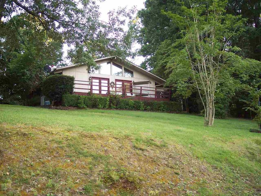 Charming home with a view ready for your family! Wonderful deck to enjoy the seasonal view of Lake Catherine and privacy galore on the back patio. Inside, you will find updated flooring, new kitchen countertops, a large great room as well as a den with a beautiful stone fireplace. Floors in den are newly stained concrete and the whole house is warm and inviting. Diamondhead offers an excellent golf course, large swimming pool and a clubhouse for your enjoyment. Have it all! BRAND NEW ROOF!