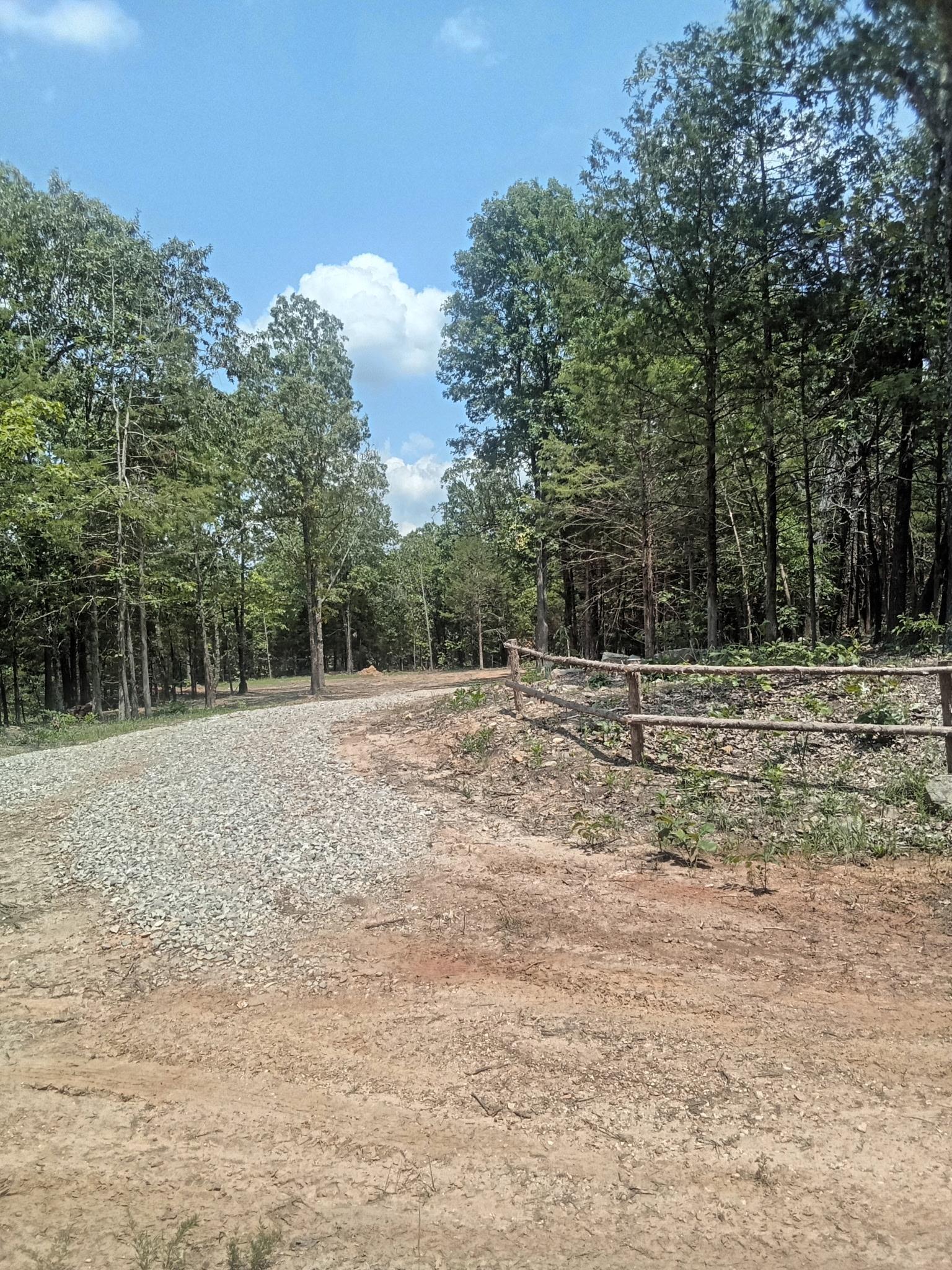 This 1.25-acre vacant lot in the picturesque foothills of the Ozarks offers a rare opportunity to build your dream home in a tranquil, rural setting. Located in north-central Arkansas, the property is primed for development, featuring essential amenities already in place. A driveway grants immediate access, while rural water is already connected, saving significant setup costs. Electric is readily available nearby, ensuring modern conveniences are within easy reach. The land has been cleared and surveyed, providing a blank canvas, and it's perced for a 3-bedroom home, streamlining the building process. Mobile Homes are allowed. Embrace the serene beauty of the Ozark landscape with this ready-to-build lot. The rural, country setting offers a peaceful escape from the hustle and bustle, while still being conveniently located in north-central Arkansas. Enjoy the tranquility of nature. This property is more than just land; it's an invitation to a relaxed, fulfilling lifestyle amidst the beauty of the Ozarks.