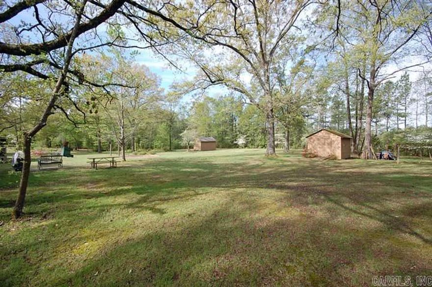 Beautiful well maintained home on gorgeous land! This 4 bedroom 2 bath with a bonus room is a must see! Enjoy country living with quick access to the city. All living areas are huge. Kitchen and bathroom have beautiful granite. Great hardwood floors in all the main living areas. Sit out in the screened in porch to have coffee and watch the deer. Two car carport and two outside storage buildings. Call today to see this great property. This can also be bought with just 3.6 acres for $215,000.