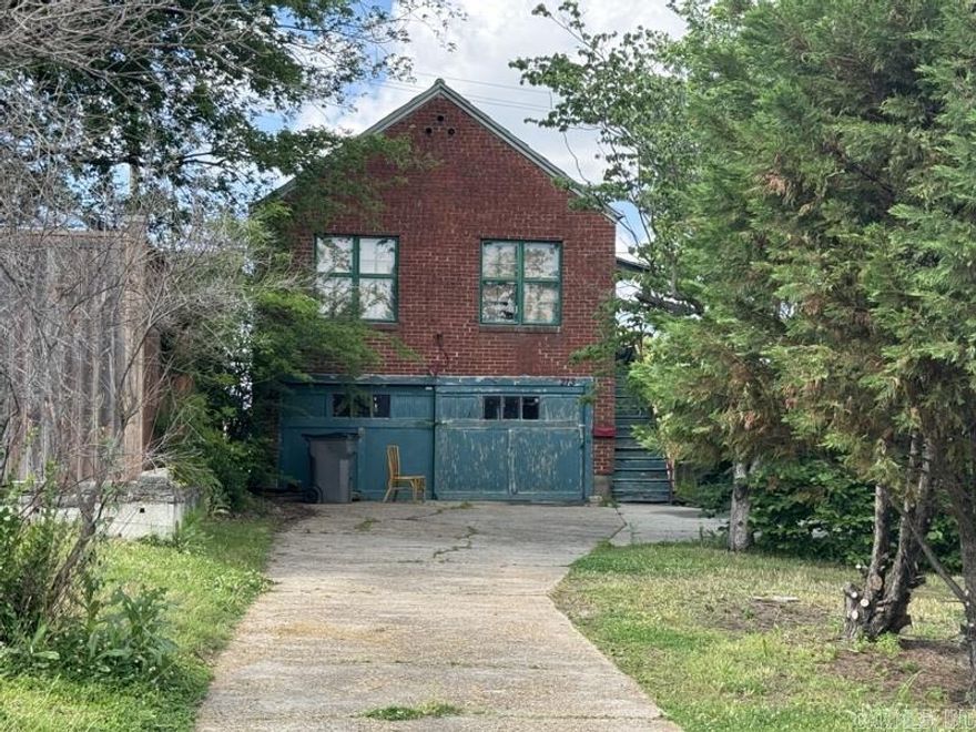 Great location with lots of exposure, property includes a small brick townhouse like home with garage below, 1 BR, 1 BA, includes Cooktop, Dishwasher, Garbage Disposal, Pantry, Vinyl Tile and Original Wood Floors, Bath has Single Vanity, Tub/Shower, and New Commode, Age of Roof is unknown, HVAC is approximately 10 years.  Property is zoned C-1.