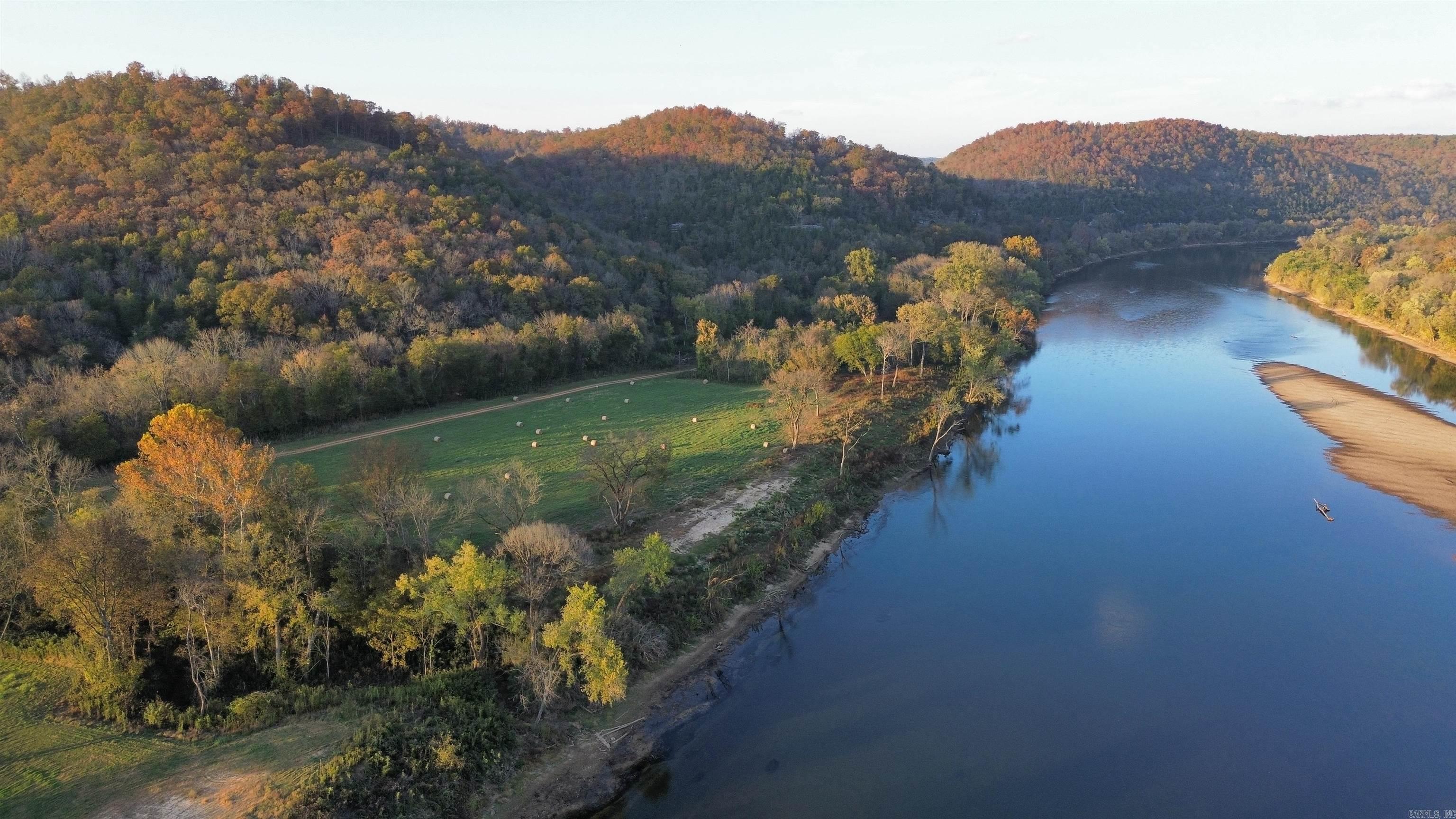 Experience the beauty of the White River from this 1.34-acre lot, offering approximately 120 feet of pristine river frontage. This stretch of the White River is known for its scenic views, with large limestone bluffs and clear waters, perfect for premium trout fishing right in your front yard! A short 10-minute boat ride brings you to the riverside community of Guion, Arkansas or two of the finest restaurants upstream in Sylamore—Anglers White River Resort and JoJo’s Catfish Wharf at Jack’s Resort—both overlooking the river unbeatable views. This lot also provides access to NEXT high-speed internet and underground electricity, for modern convenience. Frequent sightings of deer, turkey, bald eagles, and other wildlife make this location a nature lover's dream. Don't miss this chance to own a piece of the White River! Priced at $58,500. The seller also has additional river lots available!