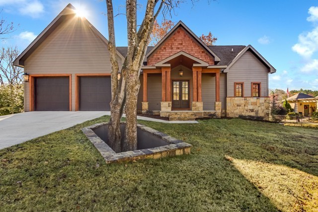 Custom designed by an award winning architect this property boasts 100 ft. of shoreline. The attention to detail is outstanding! Craftsman style with stone and cypress exterior, big beams and 2 stone outdoor fireplaces. The interior boasts 2 story vaulted ceilings in the great room, top of the line appliances, granite counters, a wine cellar, a workout room, 4 BR, 4 & 1 half baths, plus media room and bonus room over the garage. New stationary 2 stall boat dock. Come make this your new home.