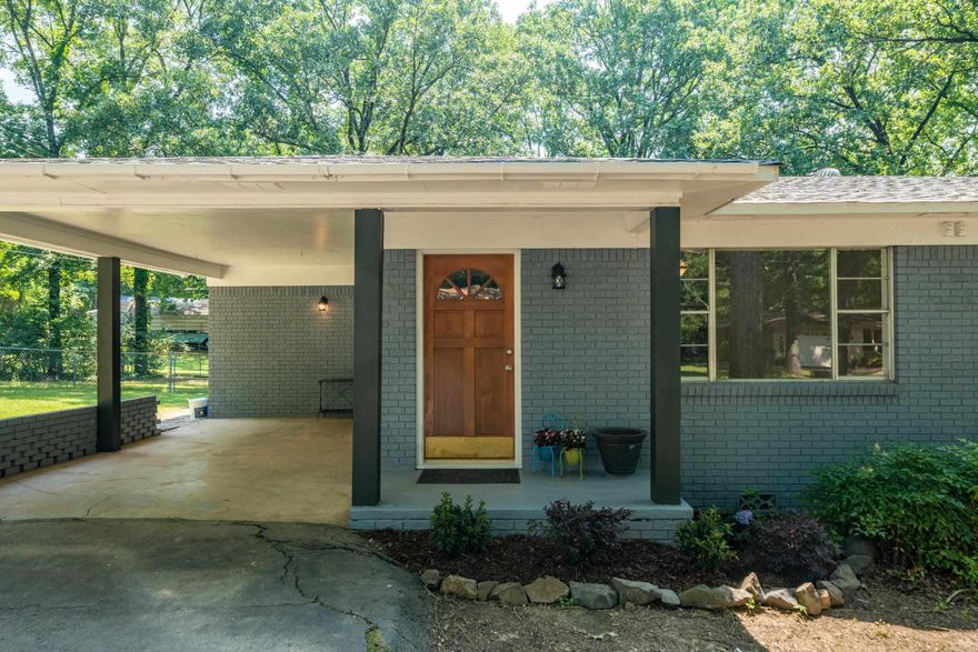 Endearing affordable 3/2 ranch style home newly listed off Lakeshore Dr. This maintenance free brick home has a fenced yard and one car carport. The "accessible beige" neutral walls coordinate perfectly with the LVP and wood floors. The family will enjoy the 10' x 26' covered wood deck this summer as well as a huge backyard the kids will love! The kitchen is brand new with resin countertops,  new appliances, a breakfast bar, and a pantry. The primary bedroom includes a gas fireplace with luxury tile surround and a beautiful bay window. The primary bathroom has LED touch mirrors, a custom tile shower, and a double-sink vanity. The laundry area has a space for full size stackable washer/dryer. There is also extra space in basement accessed thru door in pantry. Call today for a showing! Seller never occupied property, no Seller Disclosure.