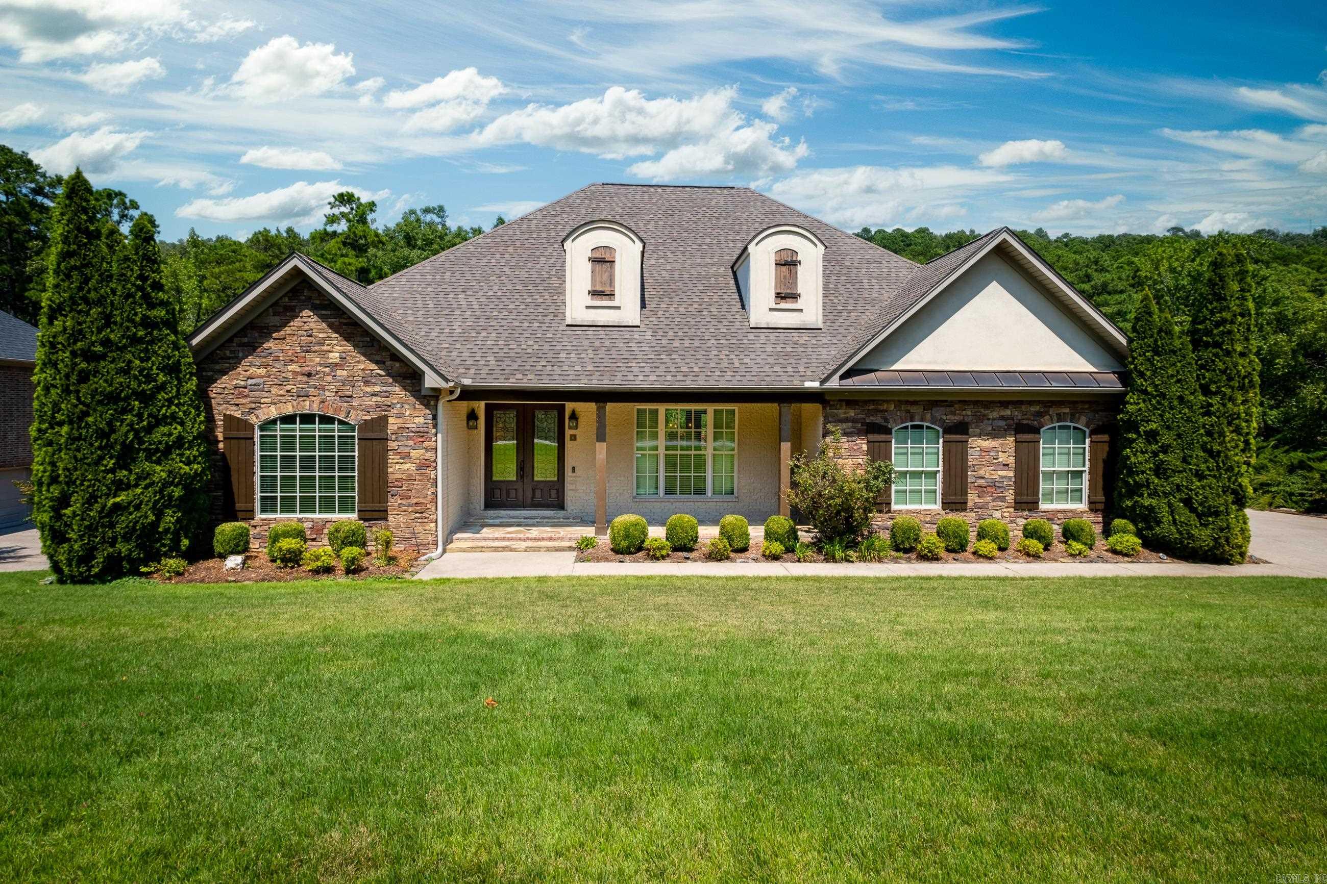 Charming traditional home on quiet cul-de-sac with view of private wooded greenspace behind the home. Two (2 car) garages = 4 car garage space. Inviting double front doors welcome you inside. Higher ceilings add to the spacious feel in this home. Beautiful hardwoods in living area. Primary suite w/spacious bath & 2 walk-in closets on main level + 2nd BR & B upstairs. Formal dining, greatroom w/ fireplace with gas logs and abundance of glass looking onto generous tiled porch for outdoor entertaining. Kitchen space designed large enough for casual dining and/or kitchen den. Laundry w/sink & extra storage. Two stairways lead to generous living space on lower level with abundance of storage areas, One bedroom w/ en-suite bath & 2 more bedrooms share the 4th full bath, Bonus room with built-ins plus office space. Lower level opens to patio overlooking wooded privacy. Features include granite kitchen countertops, big walk-in-pantry and abundance of cabinets. Primary bath has granite his and her vanities, tub & walk-in shower. Within walking distance to recreational area with pool, park, playground and tennis courts. 2nd owner-Bulder's personal home (River Rock Builders). Agent remarks