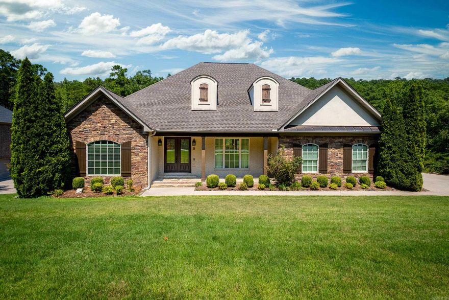 Charming traditional home on quiet cul-de-sac with view of  private wooded greenspace behind the home. Two (2 car) garages = 4 car garage space. Inviting double front doors welcome you inside. Higher ceilings add to the spacious feel in this home. Beautiful hardwoods in living area. Primary suite w/spacious bath & 2 walk-in closets on main level + 2nd BR & B upstairs. Formal dining, greatroom w/ fireplace with gas logs and abundance of glass looking onto generous tiled porch for outdoor entertaining.  Kitchen space designed large enough for casual dining and/or kitchen den. Laundry w/sink & extra storage. Two stairways lead to generous living space on lower level with abundance of storage areas, One bedroom w/ en-suite bath & 2 more bedrooms share the 4th full bath, Bonus room with built-ins plus office space. Lower level opens to patio overlooking wooded privacy. Features include granite kitchen countertops, big walk-in-pantry and abundance of cabinets. Primary bath has granite his and her vanities, tub & walk-in shower.  Within walking distance to recreational area with pool, park, playground and tennis courts. 2nd owner-Bulder's personal home (River Rock Builders). Agent remarks