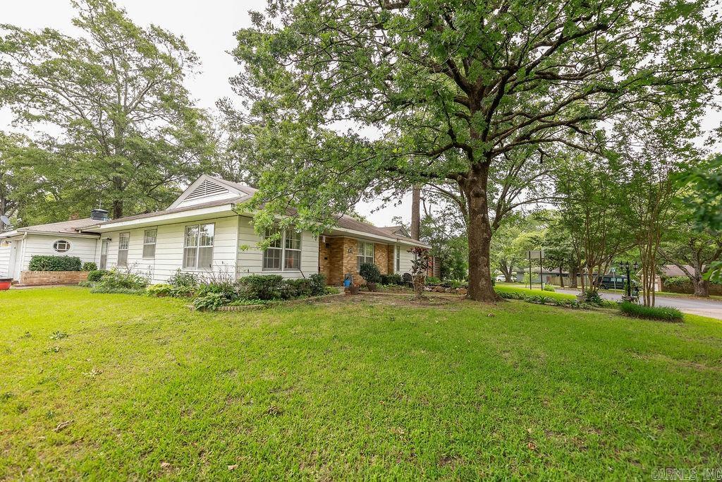 Move in ready - 3 Bedroom, 1.5 Bath home located on a larger corner lot. Fenced back yard. New gas hot water heater 3 years ago, new outside plumbing drain pipes (upgraded to pvc) roof was put on about 10 years ago, gas fireplace, high ceilings, minutes from everything (in the heart of el dorado) only blocks from downtown, in the center of all schools, blocks from arboretum, garbage disposal, 7 foot privacy wall (not fence), well stocked gold fish pond, wide assortment of blooming flowers and shrubs that come back year after year, 3 outbuildings, ample inside storage, patio, 4 doors that lead to the backyard, backyard has gates that can be locked, equipped with security system (though batteries to replaced around windows) hardwired smoke detectors (in the security system) also has inside motion detectors.