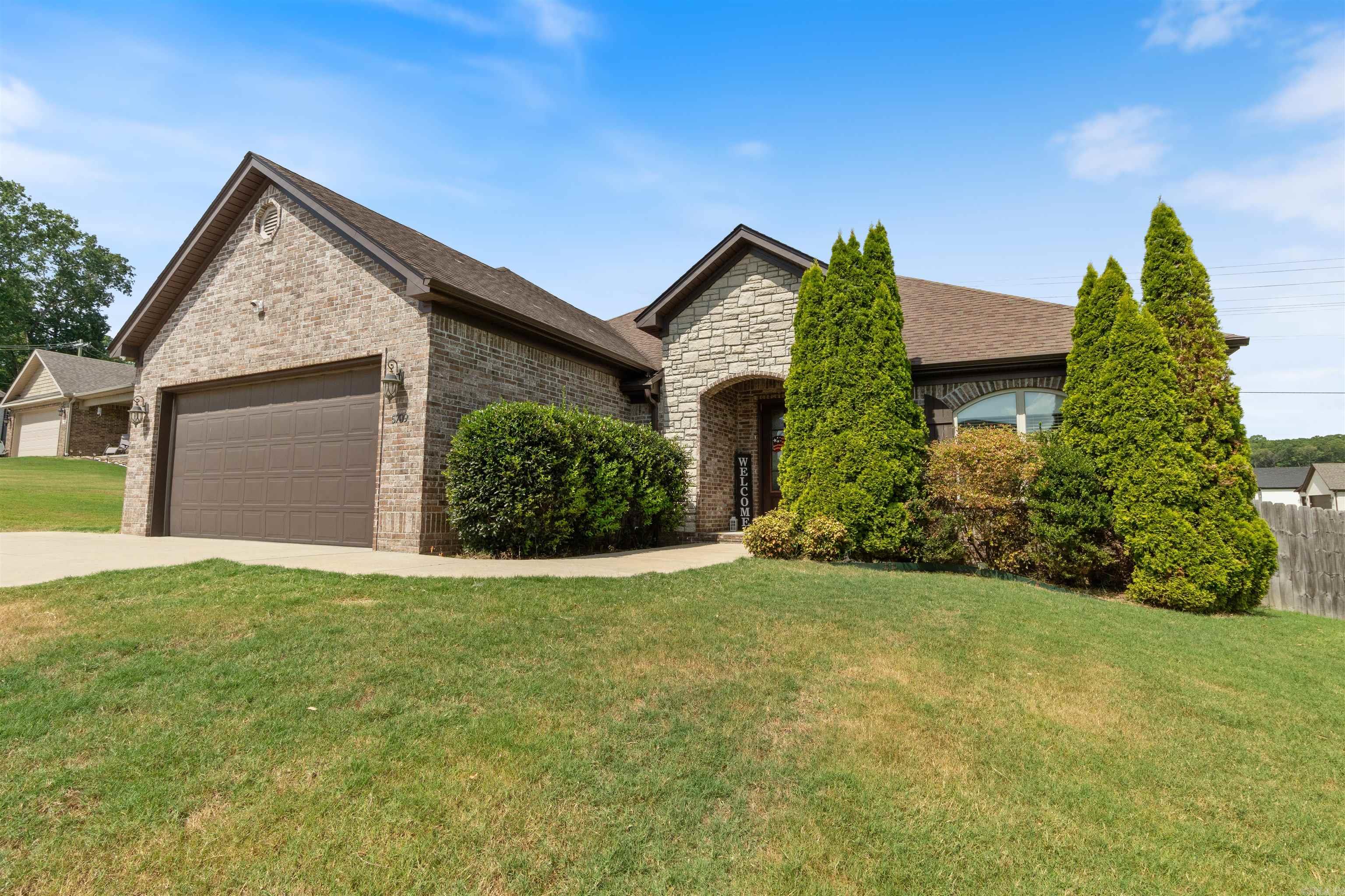 ***All-Brick Beauty w/ Brand New Roof (Coming Aug 2025) in Prime Bryant Location*** Custom-built 1 owner home featuring over 2000 SF 3 beds/2 baths on the main level plus a flex room and half bath upstairsāideal for 4th bedroom or office. Soaring 12' ceilings, rich crown molding, built-ins, and a cozy gas fireplace set the tone in the living space. Kitchen features granite countertops, stainless steel appliances, custom cabinetry, and a HUGE walk-in pantry. Mudroom with built-in cubbies, spacious laundry with direct access to the XL walk "through" closet of the primary suite. Engineered wood floors flow through living, kitchen, & dining with ceramic tile in wet areas. The covered back porch is perfect for calling the hogs with the mounted TV that will convey. HVAC serviced twice annually, separate mini split unit for upstairs. Storage GALORE including floored walk-in attic space, multiple closets, tool organizer in garage and more. Gutters, French drain and fully fenced backyard, EXTRA driveway parking spot, outside storage building and security system. Lots of custom upgrades inside and out. Minutes from I-30, Bryant Schools, and all the conveniences of Springhill and Bryant Pkwy!