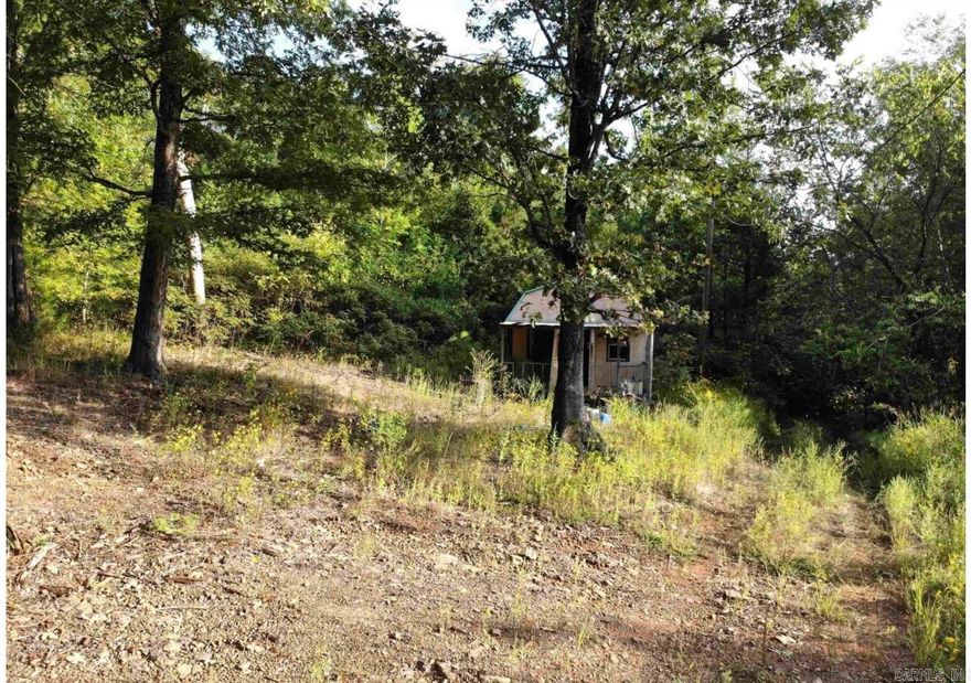 Wooded lot with a storage barn.  Land is sloped and in need of cleaning and some clearing.  Mineral rights do not convey. Owner financing available with the following terms. $5,000 down payment plus closing costs, Monthly payment will be approximately $600 plus the $19.99 monthly escrow fee. *Property is accessed through a prescriptive easement (not deeded).