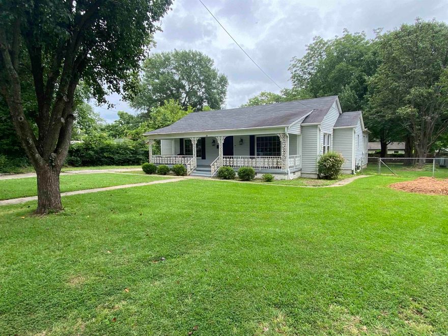 This home is breathtaking, featuring large, new windows in every room that flood the space with natural light. It boasts three bedrooms and two baths, with a split bedroom layout, spacious den, and modernized bathrooms. The original hardwood floors add charm throughout most of the house. There's an attached two-car carport leading to a dual-purpose garage, currently serving as storage or a workshop. Nestled on nearly half an acre, the property is adorned with beautiful, mature trees and an expansive front porch—perfect for savoring your morning coffee or bird-watching in the afternoon. All this sitting on a low traffic cul-d-sac.  This home truly has it all.