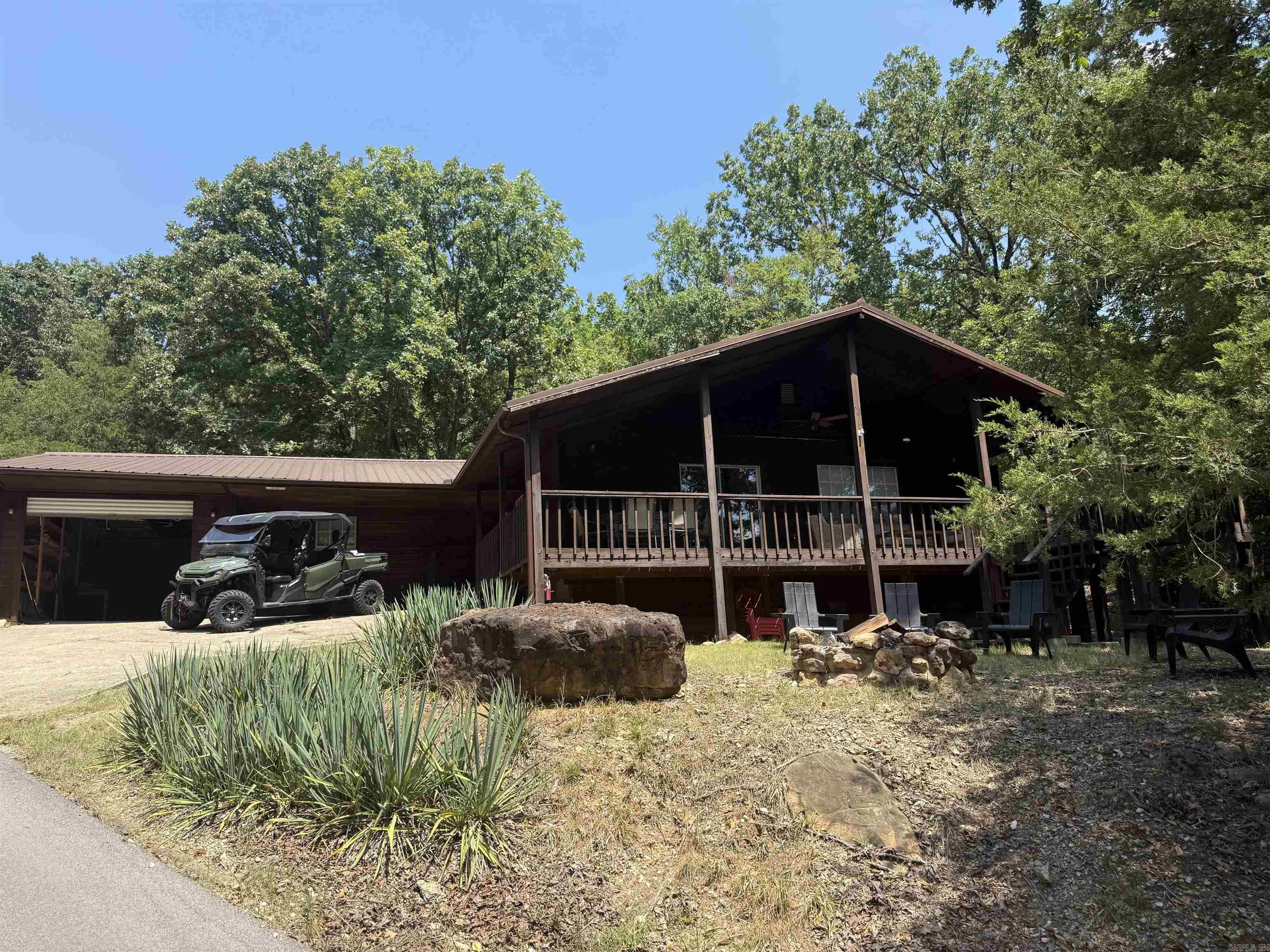 Welcome to this stunning 3 bedroom, 3 bath Lakeview home offering the perfect blend of comfort and character. Step inside to find a light-filled living area featuring a soaring ceiling with exposed wood that creates a warm, inviting atmosphere. The kitchen and bathrooms shine with freshly painted cabinets and trim giving a crisp updated look. Enjoy morning coffee or evening sunsets on the wrap around deck, perfect for entertaining. Outside, gather around the fire pit and take in the peaceful surroundings. This home also features a large garage with a work area and built in shelves, providing plenty of storage and space. HOA $150 annually.