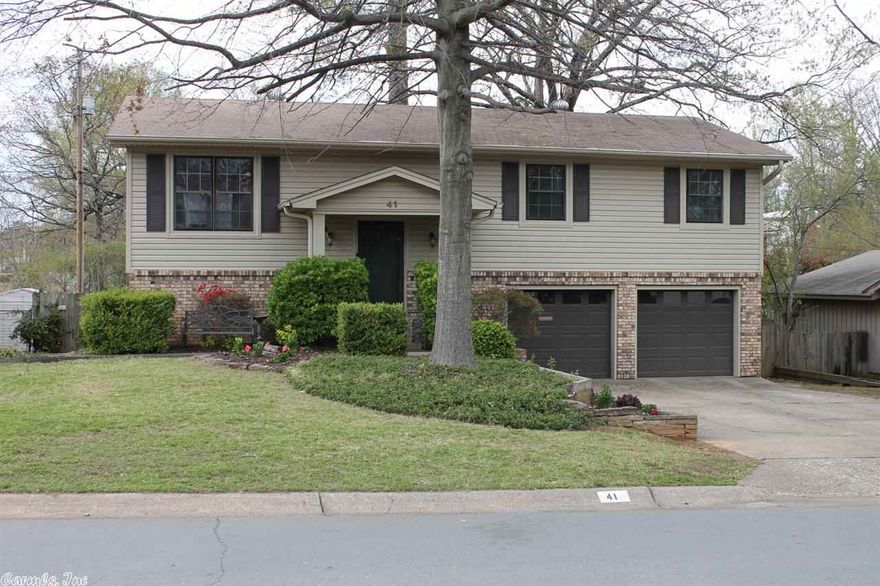 Don't miss this great updated home that features 2 living areas and hardwood flooring through out entire home. Upstairs are 3 BR and 2 baths. Downstairs a guest bedroom with half bath and den area with built-in bookcases. Surround speakers convey. Kitchen has breakfast bar with glass rack, gas stove, pantry with refrigerator conveying. Separate breakfast/dining area. HVAC less than 5 years old.New water heater in 2014. Fully fenced backyard. Vinyl siding & gutters added in 2011. Agent see REMARKS.