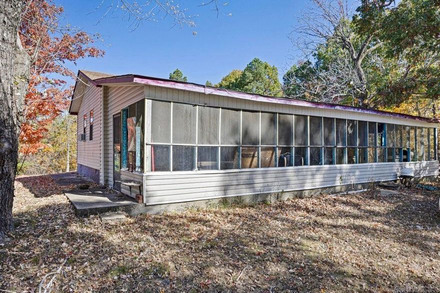 THE SUNSETS ARE SPECTACULAR! HUNTERS PARADISE!!! 10 ACRES THAT JOIN THE NATIONAL FOREST AND HWY 7! THIS 2- OR 3-BEDROOM HOME HAS A LARGE SCREENED IN PORCH TO SIT AND ENJOY QUIET OF COUNTRY LIVING. DEER, TURKEY, BEAR, SQUIRREL AND WILD HOGS CALL THIS LAND HOME. HOME!! IF COUNTRY LIVING IS YOUR DREAM OR HUNTING CABIN OR A GET A WAY THIS IS THE ONE YOU HAVE BEEN WAITING ON!! THIS IS LOCATED 1/4 MILE FROM ROTARY ANN REST AREA.