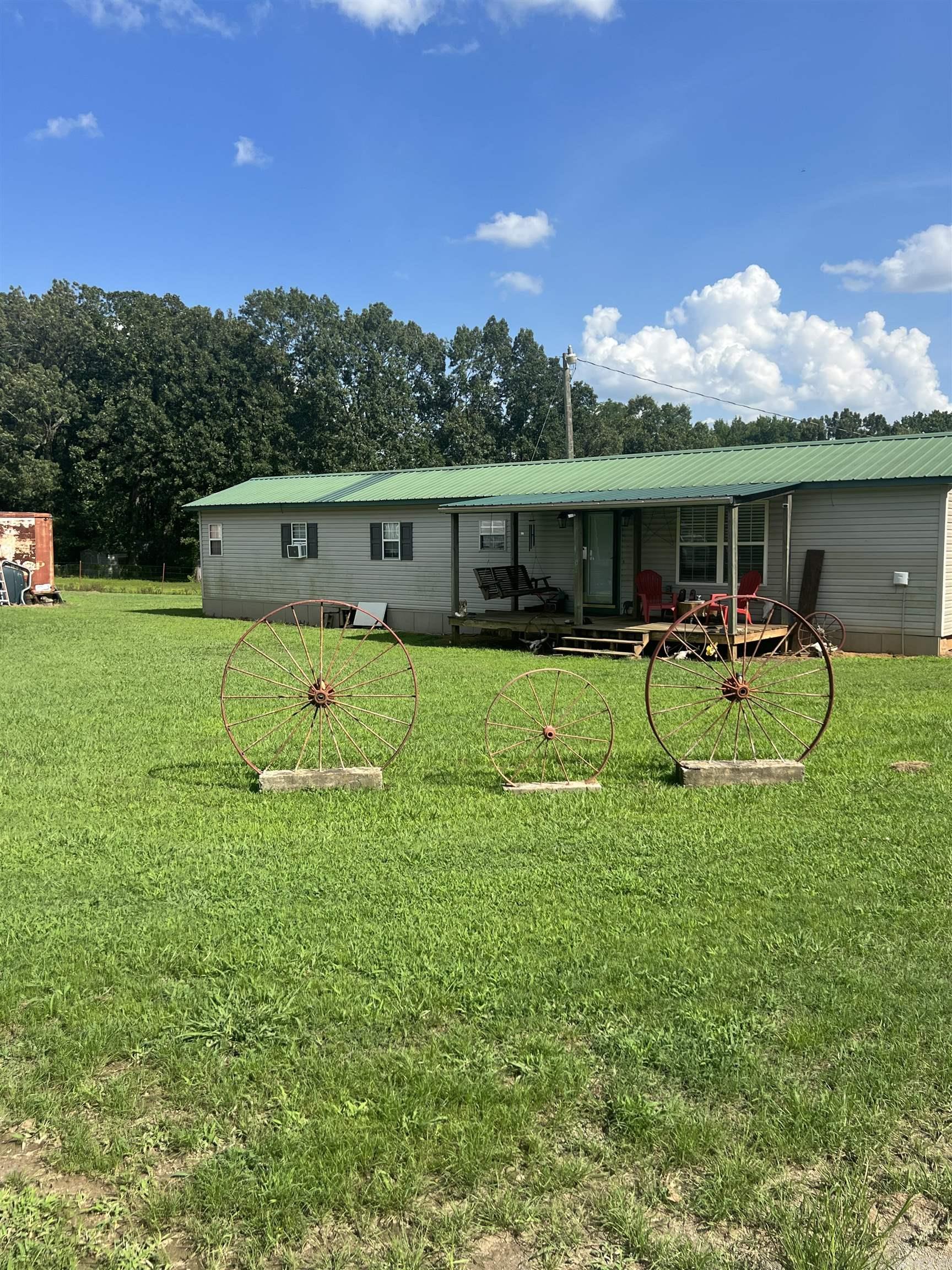 If you want the country life you have found it. Great place to run cattle, hunt, or build your dream home. This estate offers a cozy home that's been completely updated. Relax on the front porch or work on a project in the shop. The shop and the home sit on the hill barely visible from the road. Bayou Meto runs through the back slither piece of land offering you a nice water feature. Call today for your own personal showing.