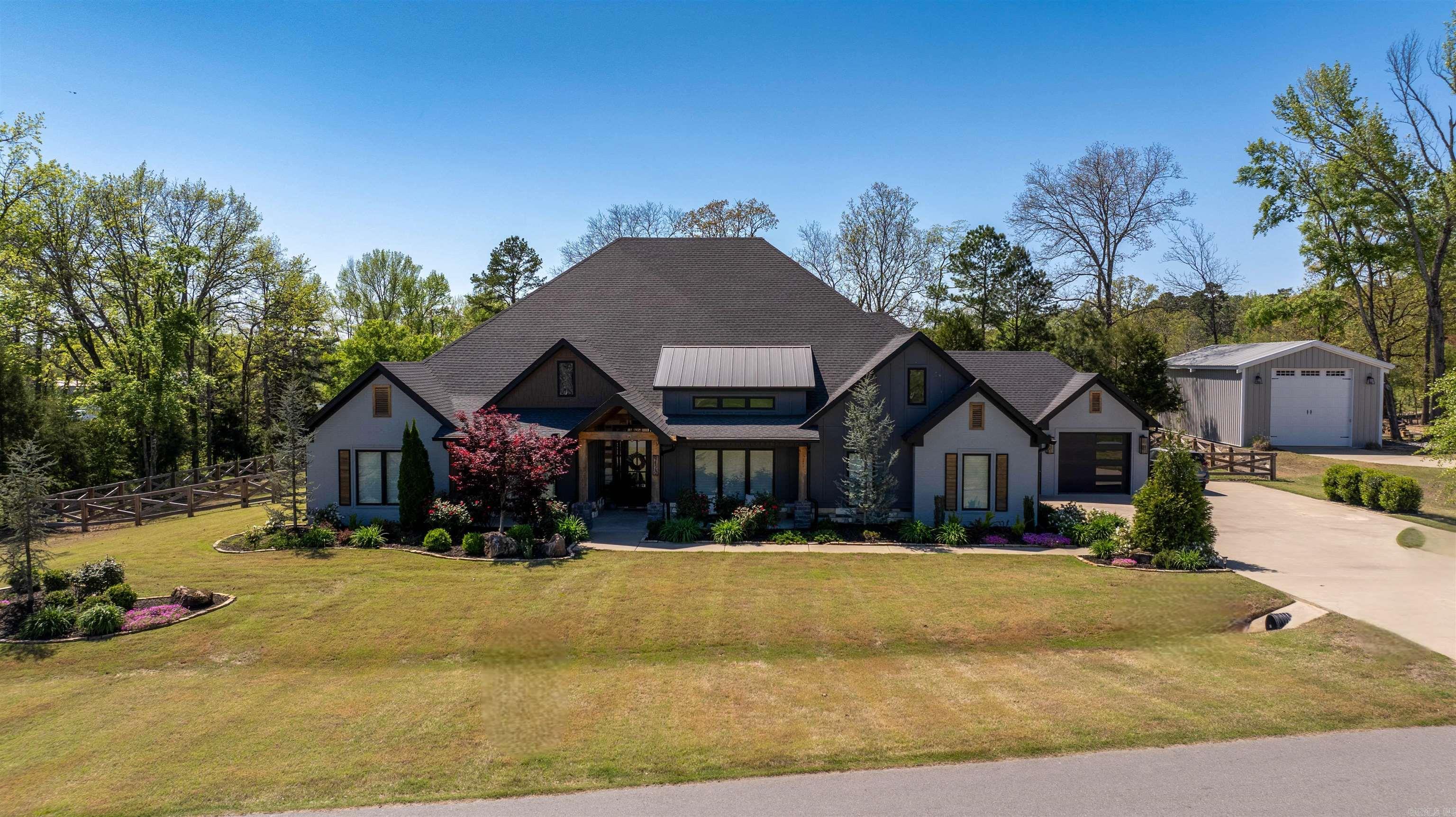 Gated subdivision!! This home sits on .98 acres. Side load garage, extra landscaping with large front porch. This home is meant for entertaining with a covered back porch with outdoor kitchen . Entry has office, great room has large windows looking over covered back porch. Kitchen has custom cabinets and island, also a bar area, double oven, gas cooktop, walk in pantry. Laundry room has sink and lots of cabinets, has enough space for extra pantry. Primary bath has custom tile shower with free standing tub, his and hers vanities. Extra large walk in closets. Other bedrooms have their own bath. Has extra living area or other bedroom.