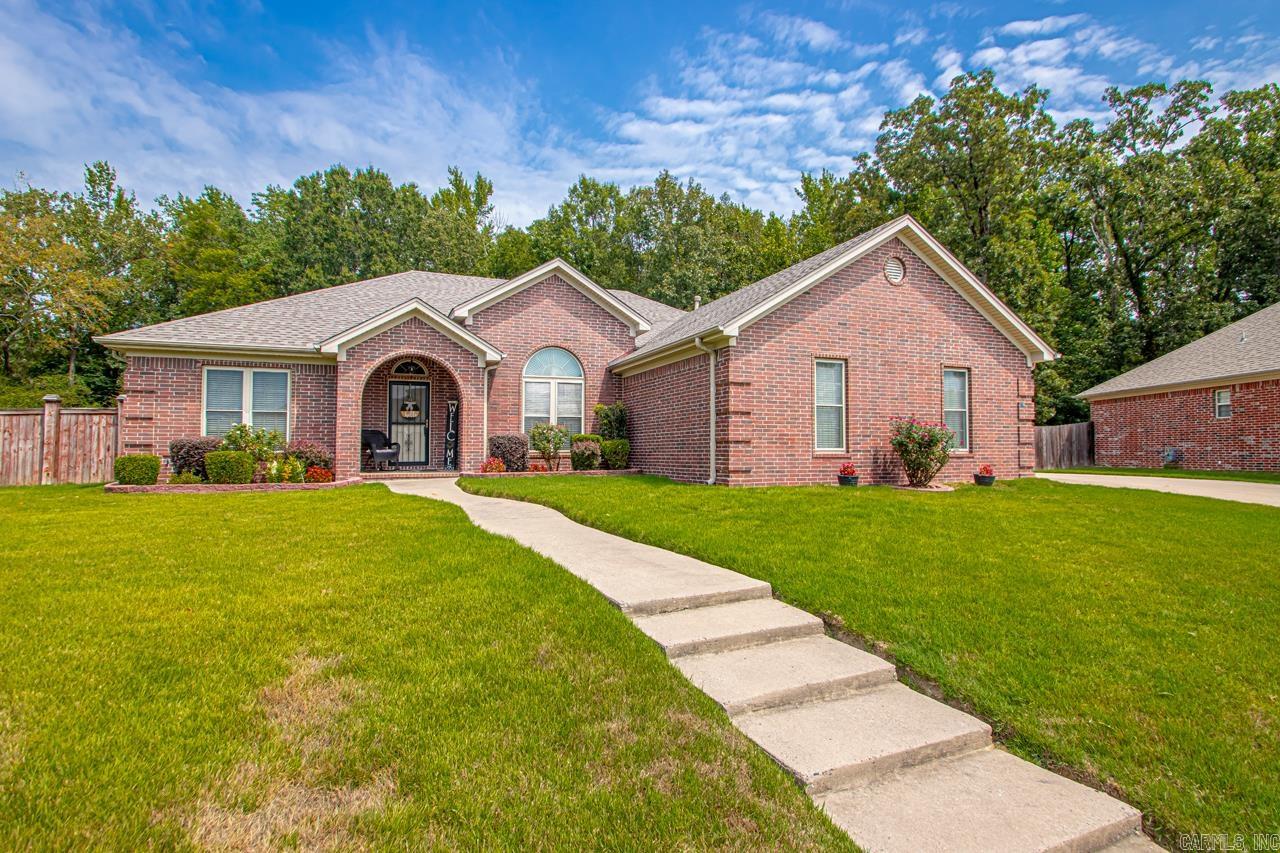 Discover refined living at 26 Congressional Drive in Kenwood Estates, West Little Rock. This 4-bedroom, 3-bath, 2,859 sq. ft. home features a split floor plan, two living areas, and a striking double-sided fireplace. A private guest/in-law suite adds flexibility, while the open kitchen flows into the main living space for effortless entertaining. The primary suite offers a whirlpool tub, separate shower, and walk-in closet. A versatile bonus room opens to the fully fenced half-acre yard—perfect for gatherings. Recent updates include a new roof and HVAC. With an oversized side-entry garage, storage shed, no HOA, and a prime location near dining, shopping, and top schools, this home blends space, style, and convenience.