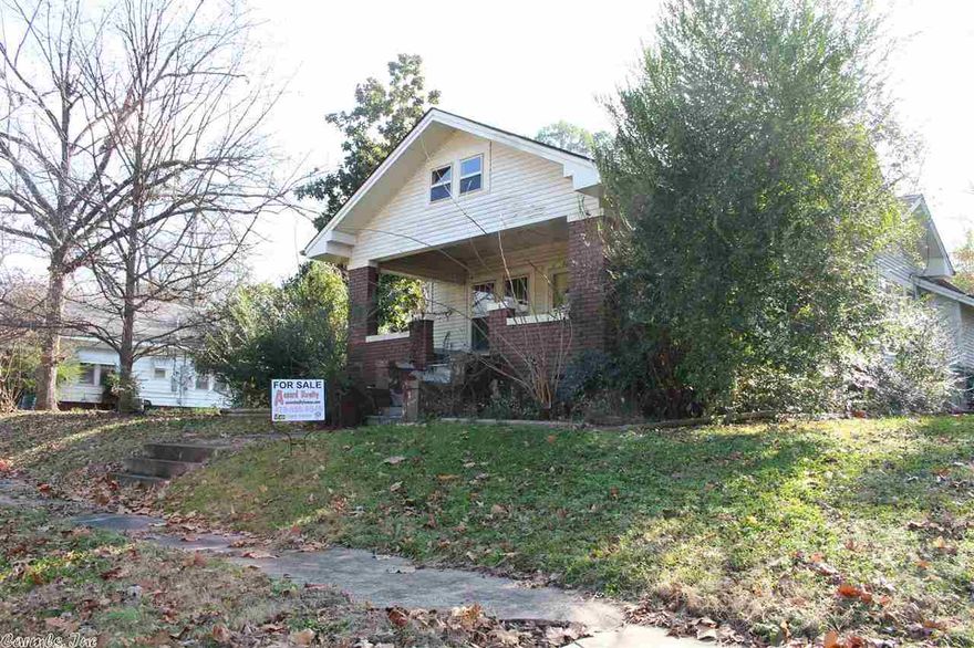 Large living, dining area. with high ceilings. Fireplace insert in fireplace. Outbuilding.  Being sold AS-IS.