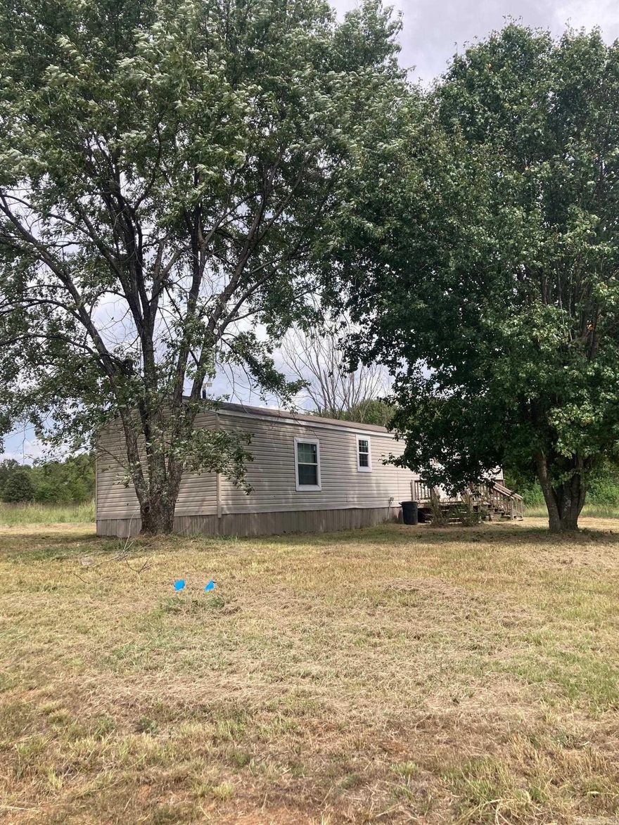2017 Clayton 16x76 is well cared for with vinyl siding and shingle roof. Master has large closet, double sink vanity, soaker tub and separate shower. The land is 5.8 acres with large trees, front and rear porches and an outbuilding.