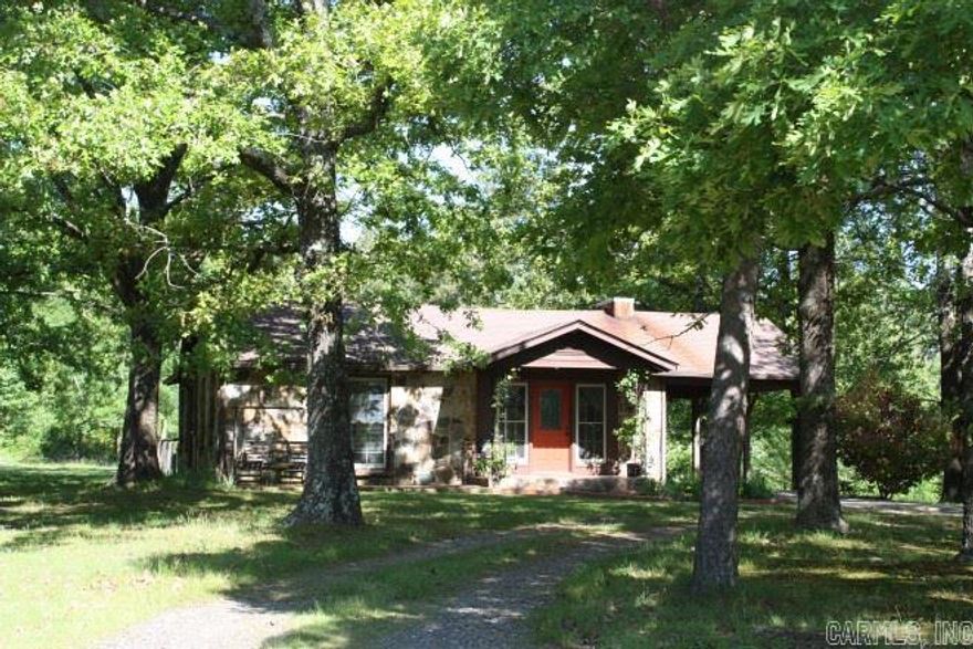 !!Home Sweet Home!! This charming rock home on 2.45 acres, with large trees scattered across fenced lawns, makes a lovely setting to call home at the edge of town! Enjoy mountain views from the deck, central heat & air, and a carport off kitchen. This well-maintained home  has a gated entrance, 2 carports, shed, and extra yard for pets.   Sunny bedrooms, updated bathroom, and roomy living area with working fireplace converted to gas heater. $104,000