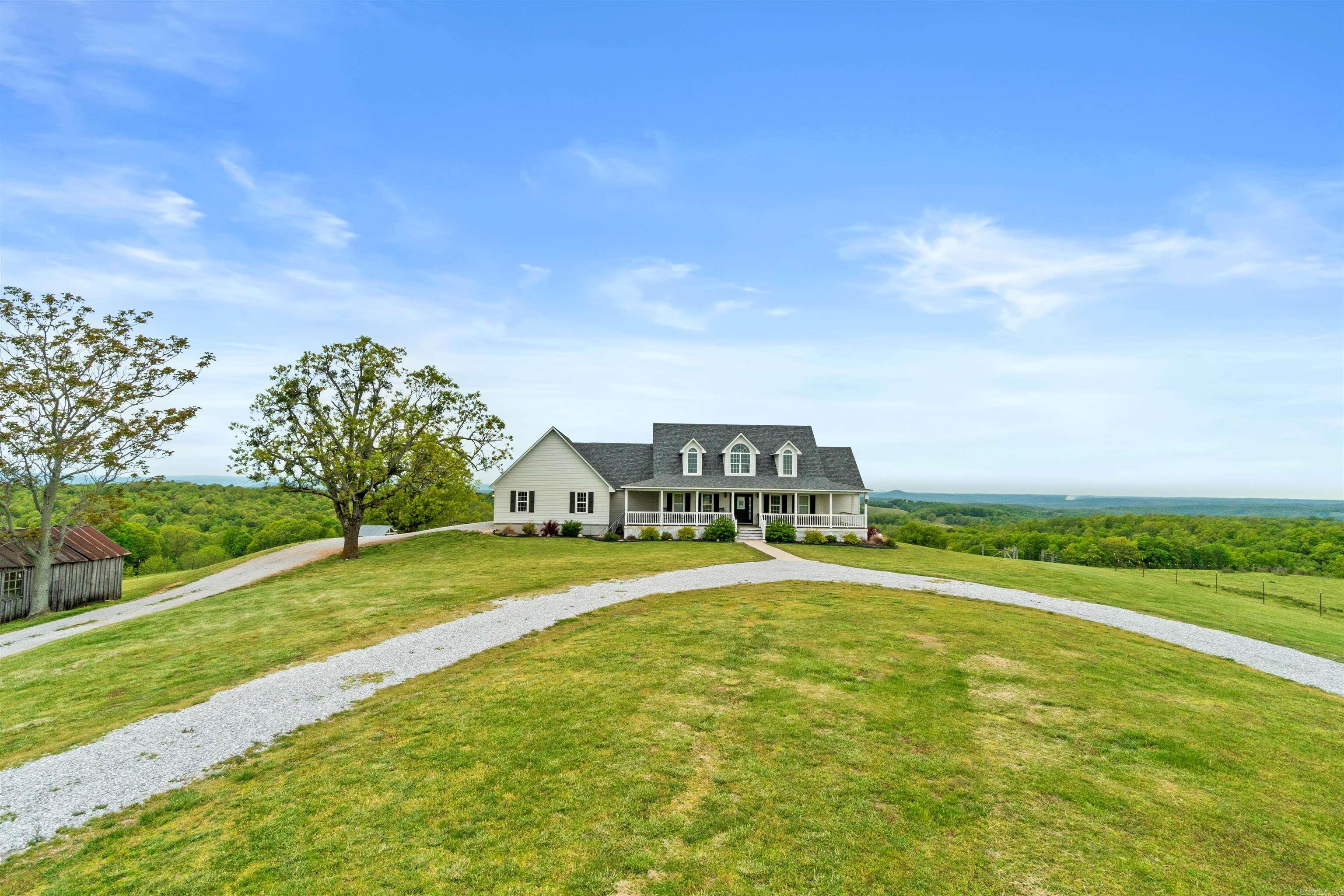 Check out this luxury ranch just 6 miles from the Buffalo River in Marshall, AR. This home hosts an unparalleled panoramic view of the Ozark Mountain landscape with no obstructions for over 30 miles. Perched on top of 94 acres of farmland, this house sits in a class of its own with massive windows to view the stunning sunsets. The open concept floor plan creates a marquis entertaining space. The main house is essentially two homes in one with each level able to be separated or combined. The main level is a 2 bed/2 bath, laundry, large dining room, living room & kitchen with attached garage. The lower level consists of a full walk-out basement, 3 beds/1bath, full kitchen, laundry room, large living room/dining room, & a large bonus closet for storage. This lower-level suite (Victory Ranch Homestead) is an established rental on VRBO/Airbnb and generates consistent rental income. The property also features a 1 bed/1bath log cabin that is also an established VRBO/Airbnb called Victory Ranch Cabin. The views here are home to picture perfect sunsets hand-painted by God. A truly surreal, one-of-a-kind, turnkey ranch, vacation rental and home. Additional selling agent bonus.