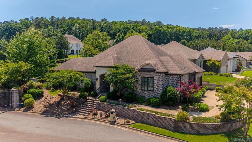 Timeless one-level home in the quiet, gated Hickory Grove neighborhood, designed and built by Melinda Markus. Built in 2014, this beautifully appointed home offers 12-foot ceilings, iron front doors, graceful arches, hardwood floors, abundant natural light, and a striking two-sided fireplace anchoring the main living spaces. The great room makes a beautiful first impression with large windows, custom drapes, built-in speakers, wet bar, and easy flow to the dining area, kitchen, and covered patio. The kitchen features generous cabinetry, a spacious island with seating, gas cooktop, butler’s pantry, and updated appliances including Café refrigerator. The private primary suite offers backyard access, spacious bath, and large walk-in closet. Two guest bedrooms share a full bath, and a separate office is positioned near the powder bath. Recent updates include new flooring through most of the home, updated lighting, tankless water heater, and newer appliances. Additional features include a brick-and-iron fenced backyard, outdoor playhouse with A/C, sprinkler system, side-load garage with parking pad, Tesla charger, walk-up attic storage, and POA-covered lawn care.