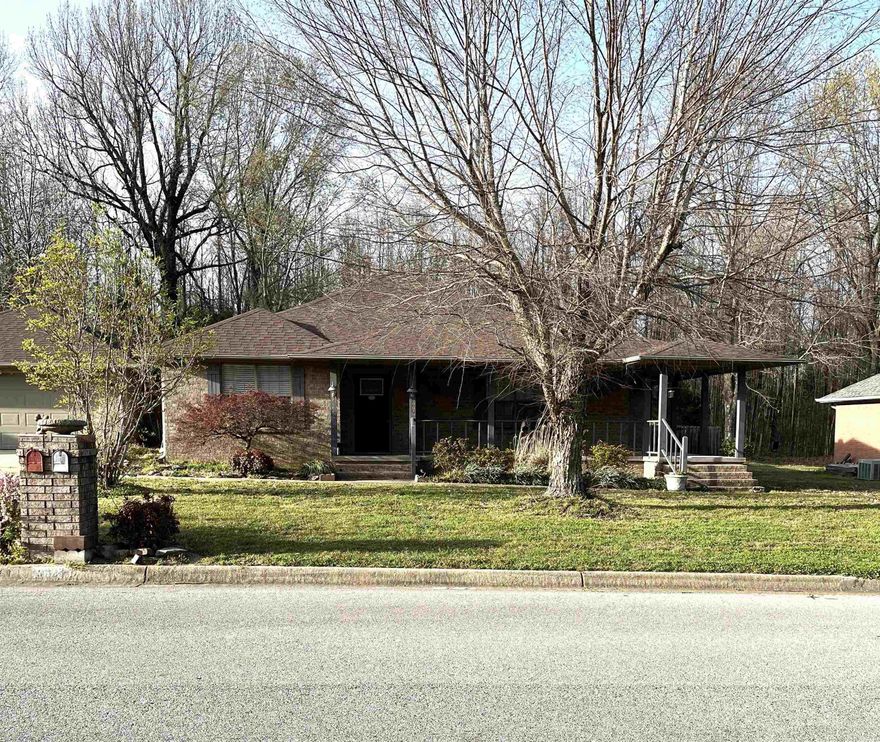 TAKE A LOOK AT THIS ONE!  3BR / 2BA Home Sitting on a Shaded Lot.  Beautiful Surround Front Porch (very rare for this subdivision).  A Separate Dining Room.  Kitchen is Roomy w/lots of Cabinets.  Living Room is HUGE w/Commercial Grade Lovely Vinyl Plank Flooring and French Doors that lead out to the Porch on the side.  Hall Bath has Handicap Custom Tiled Shower.  Master Suite has a Walk-In Closet and goes into the Bath with Jetted Tub, Walk-In Shower and New Vanity.  We have a good size outbuilding and a 20x30 SHOP in the backyard with it's own PAVED DRIVEWAY!  Established yard with lots of flowers. Don't miss your opportunity to own this Gem!  (recent updates include New Doors / Frames, Some Paint and Wall was built back between the spare Bedroom and Hall Bath.)  CALL ME!