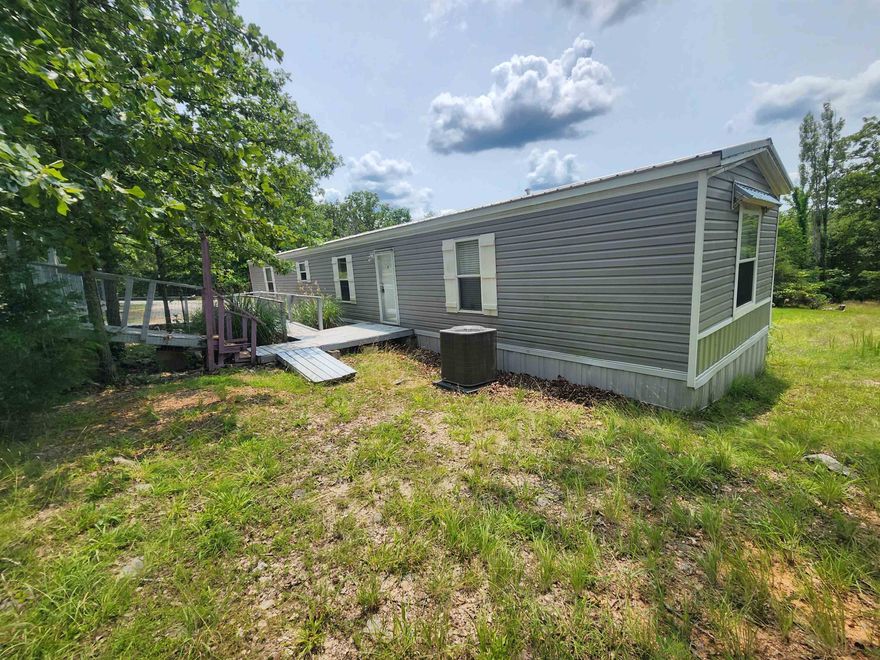 7 +/- acres M/L Beautifully landscaped with 2 mobile homes, the newer of the 2 is a 2019 3 bedroom/ 2-bathroom home with open floor plan in the kitchen dining and living room area. Very well maintained, with new carport and flooring installed. The 2nd mobile home could be used for an in-law suite, overflow guests or just a storage place, as it is now. The 2nd home could use some updating and a little TLC. It is a 2 bed, 1 bath with very good bones. There is a 30 x 30 metal barn building with roll up doors on the front and back along with an attached 20 x 17 covered parking area. The walking trails through out the front half of the property are lined with stones and gorgeous landscaping. There are some benches along the trails to sit and enjoy the sound of nature. The woods on the back half of the property would be ideal for hunters or nature lovers just looking to get deeper with nature. New chat stone driveway and parking pads. Make an appointment to see this property and come get your slice of Ozarks foothills living.