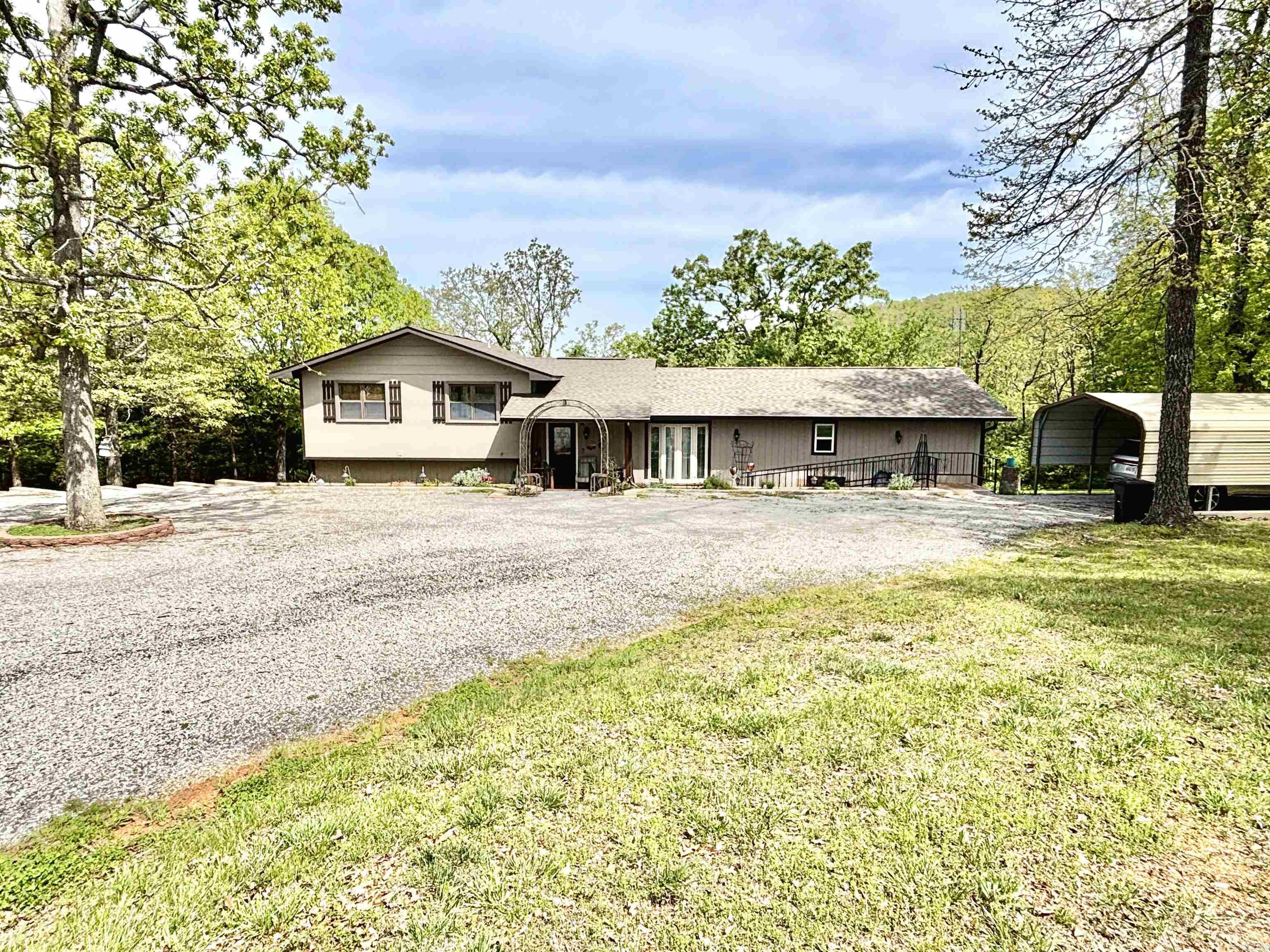 Nestled on 2 peaceful acres near beautiful Bull Shoals Lake, this 4-bed, 3-bath tri-level home offers comfort, updates, and space. Enjoy a custom-built kitchen, all new appliances, and a new HVAC system (2022). A brand-new roof was added in 2025. The lower level features a separate entranceāperfect for a guest suite. The master suite includes a large walk-in closet and thereās a spacious pantry for extra storage. Relax on multiple decks with wooded views. Property includes a separate garage/workshop and an attached shed. Minutes from boat docks and some of Arkansasās best fishing! Motivated seller.