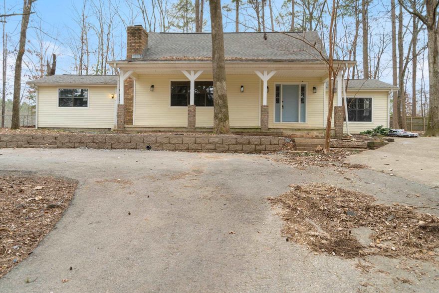 Charming 4-bed, 2-bath home on 2.78 acres, just outside Bryant city limits. Perfect spot for gardening and a hobby farm. There is even a fenced in area for your animals. The upstairs features a master suite with its own bath, while the downstairs includes three additional bedrooms. Recently remodeled with updates including 2 new HVAC units, a new roof, fresh paint, LVP flooring, stained wood ceiling in living room, granite countertops, stainless steel appliances, new shower valves and toilets, and a new deck on the back porch. The front boasts a newly built retaining wall, and the cozy living area includes a wood-burning fireplace. Agent owned.