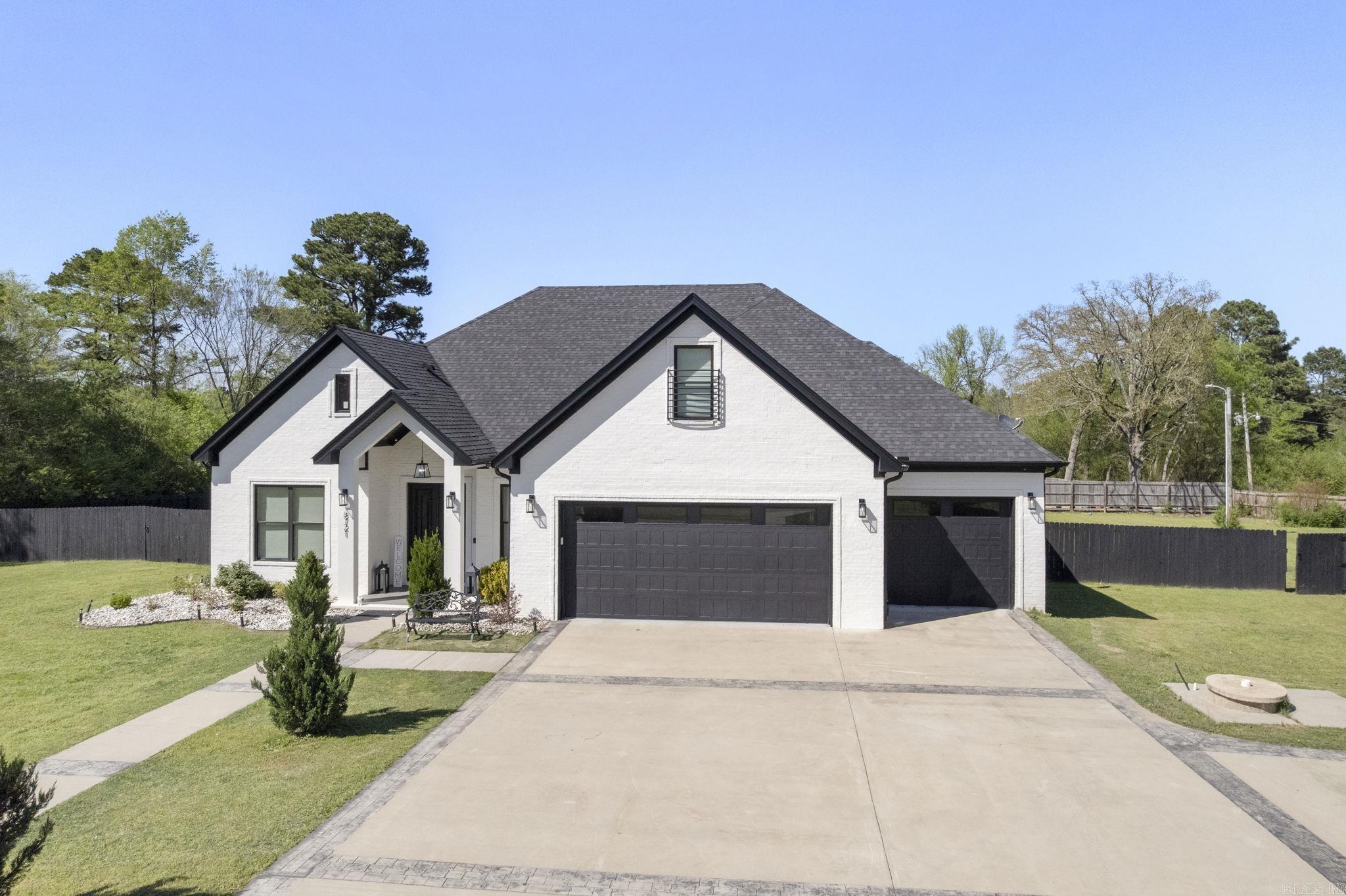 This beautifully designed custom home offers 4 spacious bedrooms, 3 full baths, a 1 half bath, perfectly blending comfort & luxury. You'll love the gourmet kitchen featuring quartz countertops & top-of-the-line commercial appliances. Rich hardwood floors flow throughout the main living spaces, complemented by soaring 8-foot doors to add a grand touch. Enjoy entertaining in the game room or relax by the outdoor fireplace in the fully fenced backyard. The dedicated office space is ideal for working from home, while the safe room provides added peace of mind. A 3-car garage offers plenty of space for vehicles & storage. This home checks every box-style, function, & location (Benton Address in Bryant School District)!