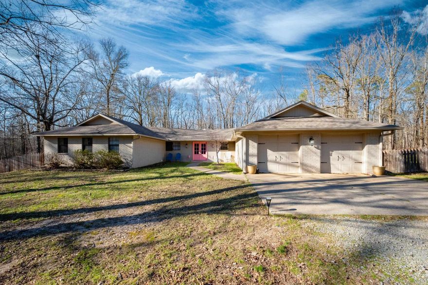 This beautiful one-level home sits on 2.3 acres in Bryant and features 3 bedrooms, 3 full bathrooms, and an office or craft room. A welcoming front porch leads to double doors opening into a bright foyer. The spacious great room boasts new flooring and a stone fireplace. The large kitchen, equipped with new appliances (2023), offers a generous island with a cooktop and downdraft, a breakfast bar, and a bar fridge. It also includes double ovens with convection, a dishwasher, and a sink overlooking the front yard. The laundry room is spacious with many uses. Two guest rooms share a full bathroom, while the primary suite fits a king-size bed and sitting area. The ensuite has a beautiful vanity and a large walk-in closet. The backyard oasis features an inground pool with a new line and pump (2022), along with a cabana/pool house, all surrounded by scenic acreage. The home also includes a new package unit (2023) and new paint throughout. Enjoy privacy, country charm, and easy access to Bryant city limits. Perfect for entertaining, this property is a must-see!