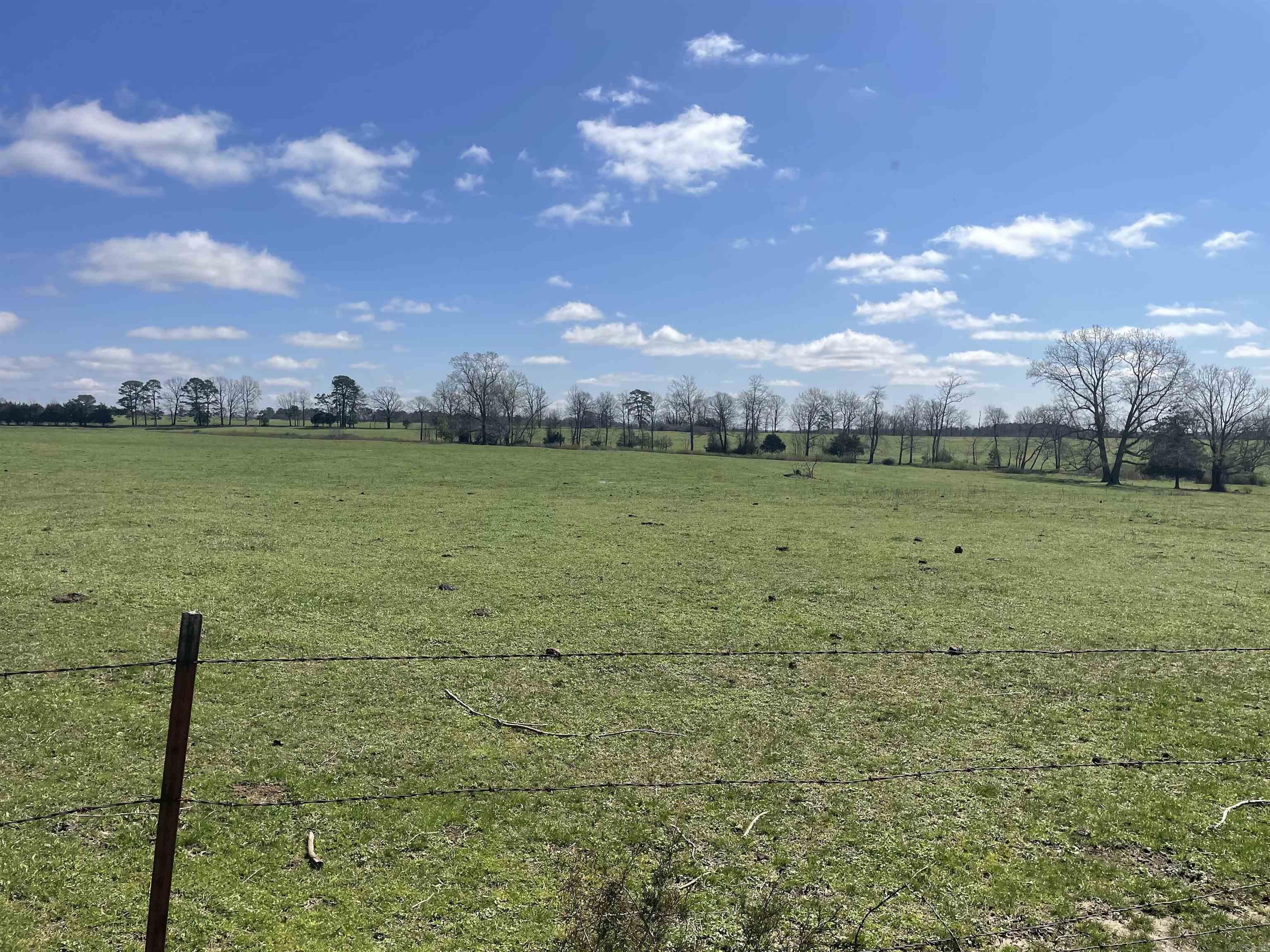 This is newly subdivided property is split into 3 and up to 11 acres This is gently slops with rural water and First Electric power. Some lots have water features such a spring feed ponds, some have trees and some are open. Take a look today and call me for further details. This lot has a area for a lake or to a hill for added features