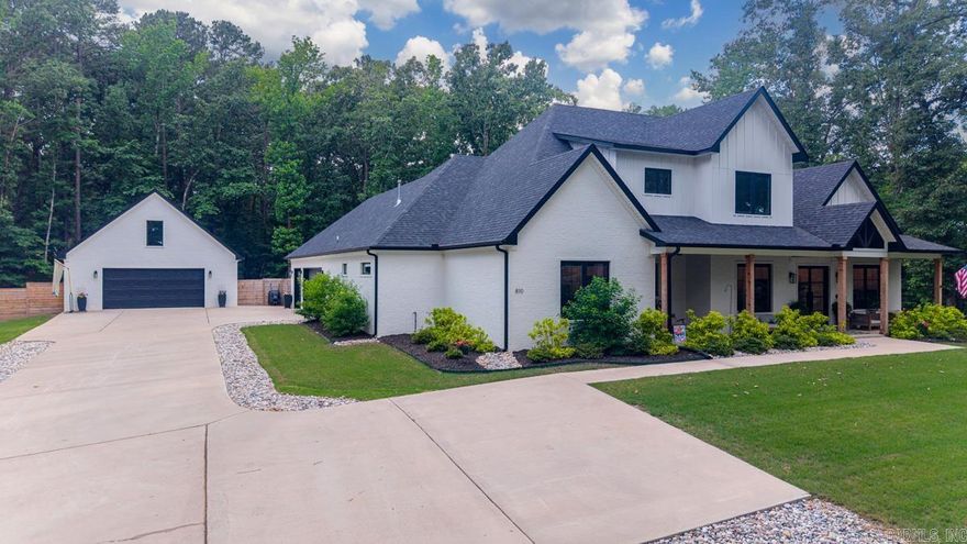Welcome to 810 Caddo, a stunning custom-built estate built in 2023, perfectly situated on 3 private acres within the Woodlands subdivision, offering the rare blend of luxury living and neighborhood amenities. This exceptional 4-bedroom home features two luxurious main-level ensuite bedrooms, a private office that could also be a dining room, an oversized laundry room, and a designer pantry complete with small appliance cabinets for effortless organizing! The heart of the home opens seamlessly to an incredible pool house/game room featuring a full bath and a dramatic glass overhead door that extends the living space onto the resort-style outdoor patio and sparkling pool w/hot tub! Upstairs, you'll find two spacious bedrooms connected by an oversized J&J bath, along with an additional loft living space perfect for work or relaxing. Every bedroom offers massive walk-in closets with built-in dressers. Outdoors, enjoy multiple inviting, relaxing areas, a fully equipped outdoor kitchen with built-in grills, sink, ss drawers & bar seating - all designed for elevated entertaining. Completing the custom masterpiece is a 30x30 Heated/cooled shop with a fully floored attic for great storage!