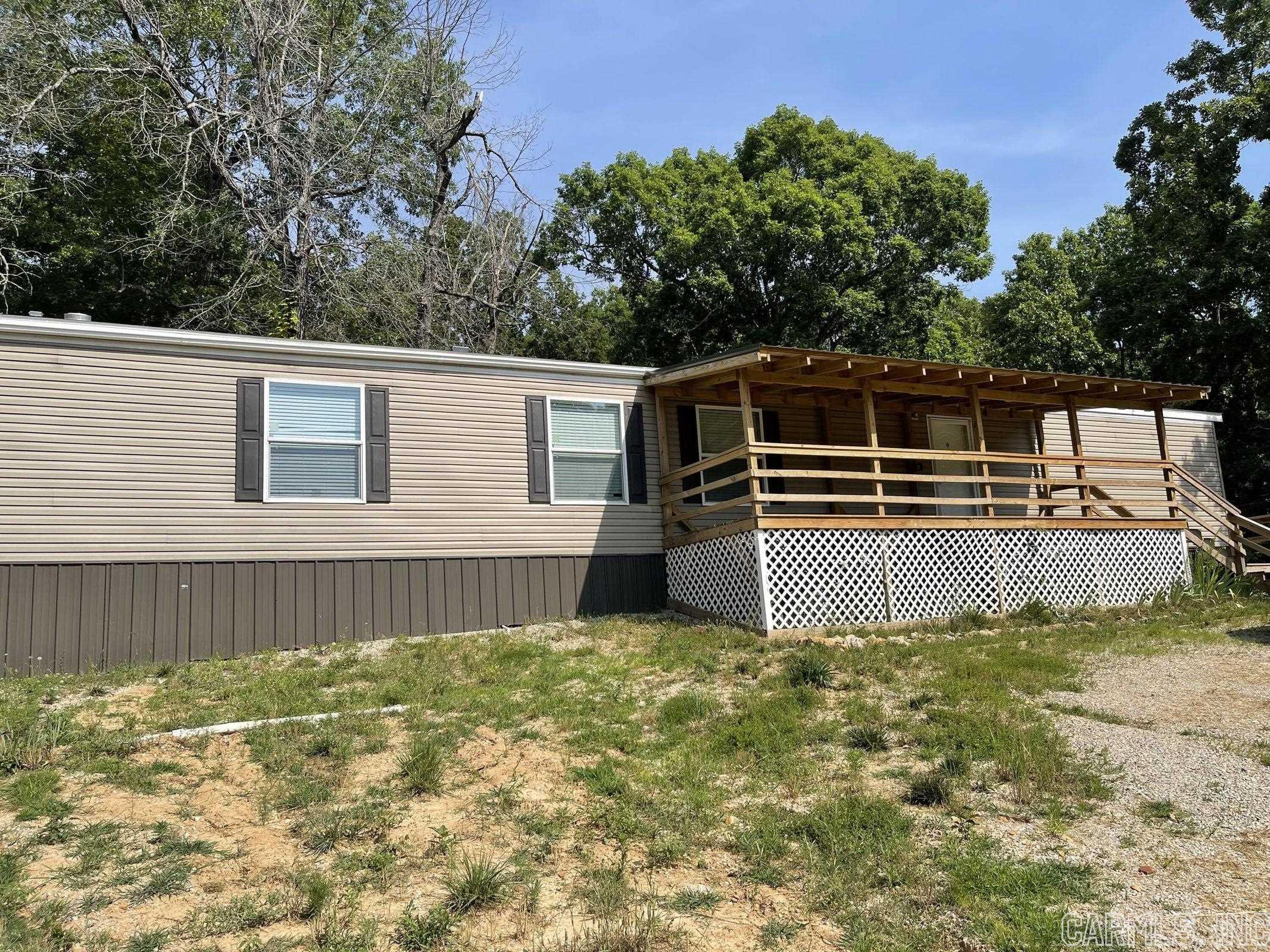 New 2021 Manufactured 3 bedroom, 2 bath home with front covered porch and back deck. Home has open floor plan with kitchen island, new appliances, dedicated laundry with the primary bedroom on separate end from the other 2 bedrooms. There is a fenced in area all ready for your fur babies. Home is tied down and has title and the HUD label so it is loan ready!